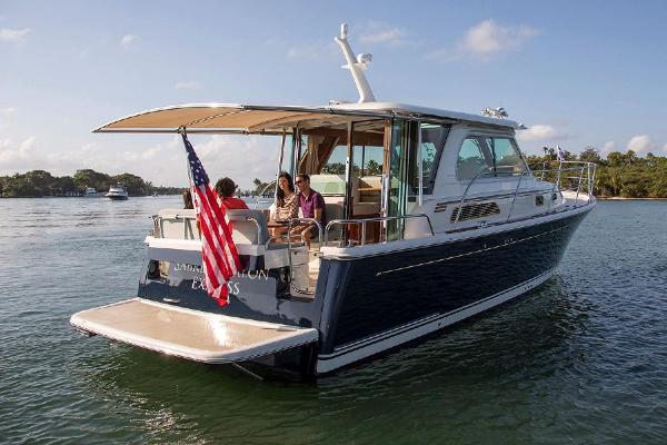 Sabre 38 Salon Express 2027 on calm water with people on board.