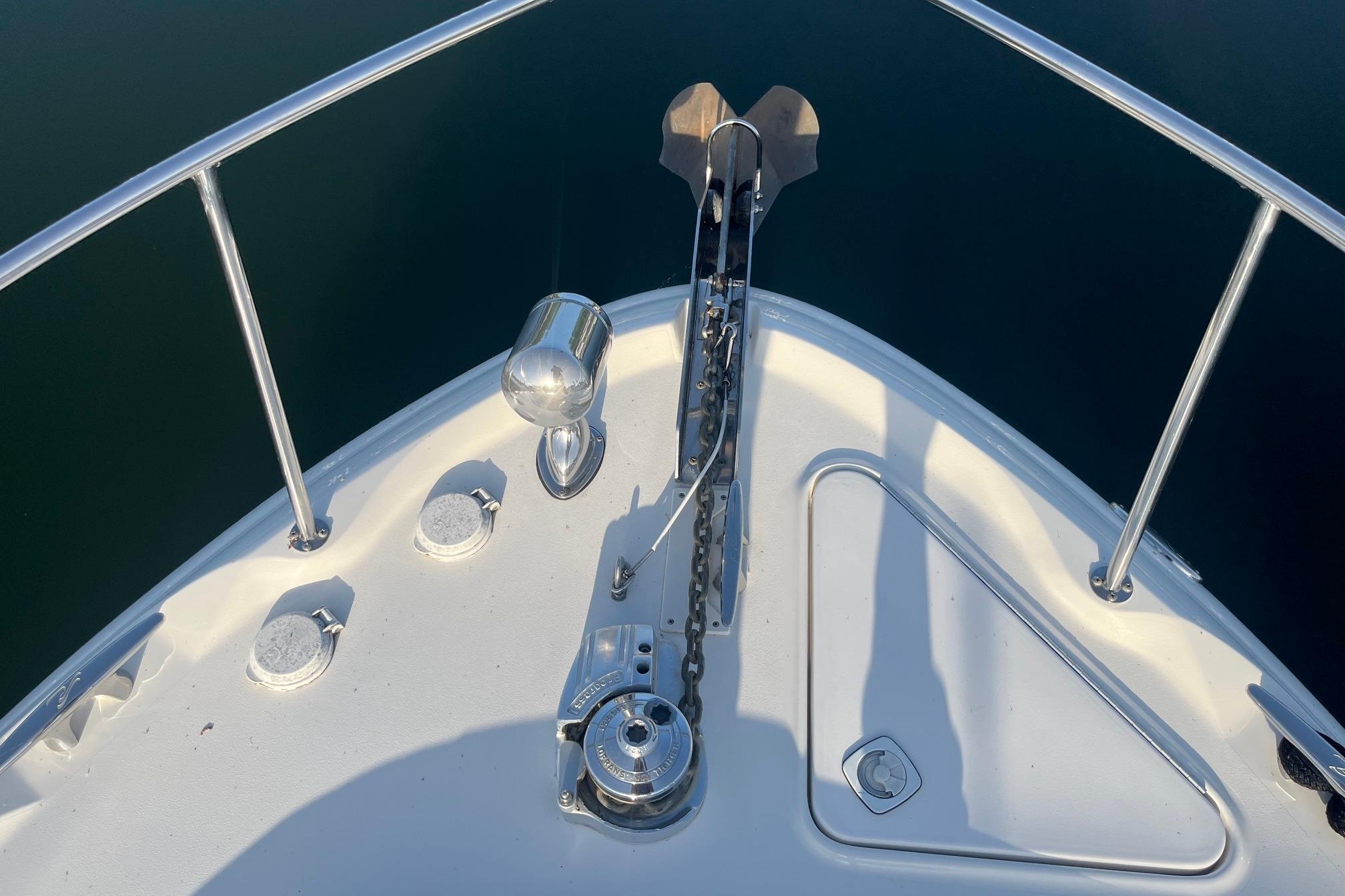 Bow of 2001 Sea Ray 340 Sundancer with anchor and railing.