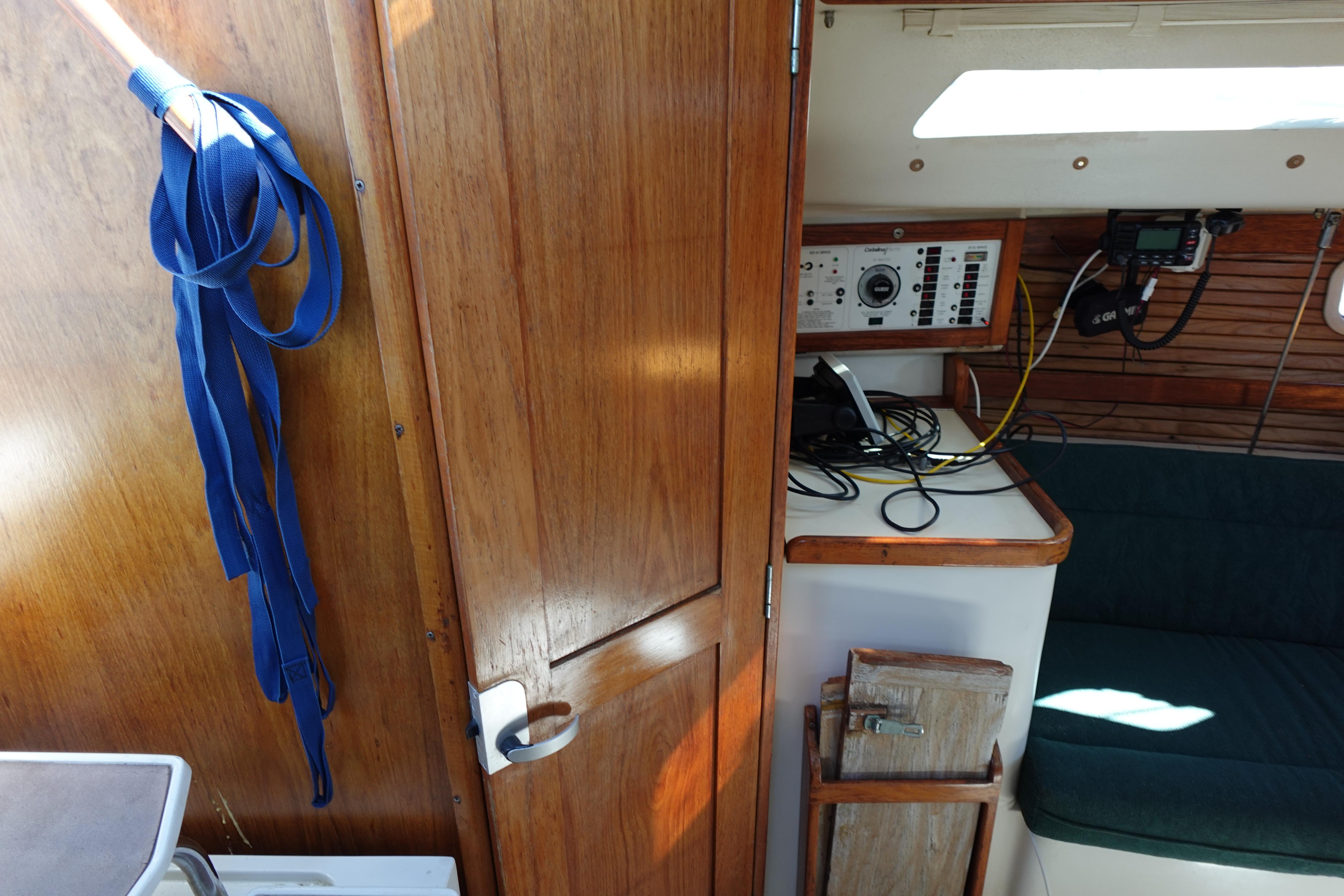 Interior of a 1997 Catalina 28 sailboat with wooden paneling and navigation equipment.
