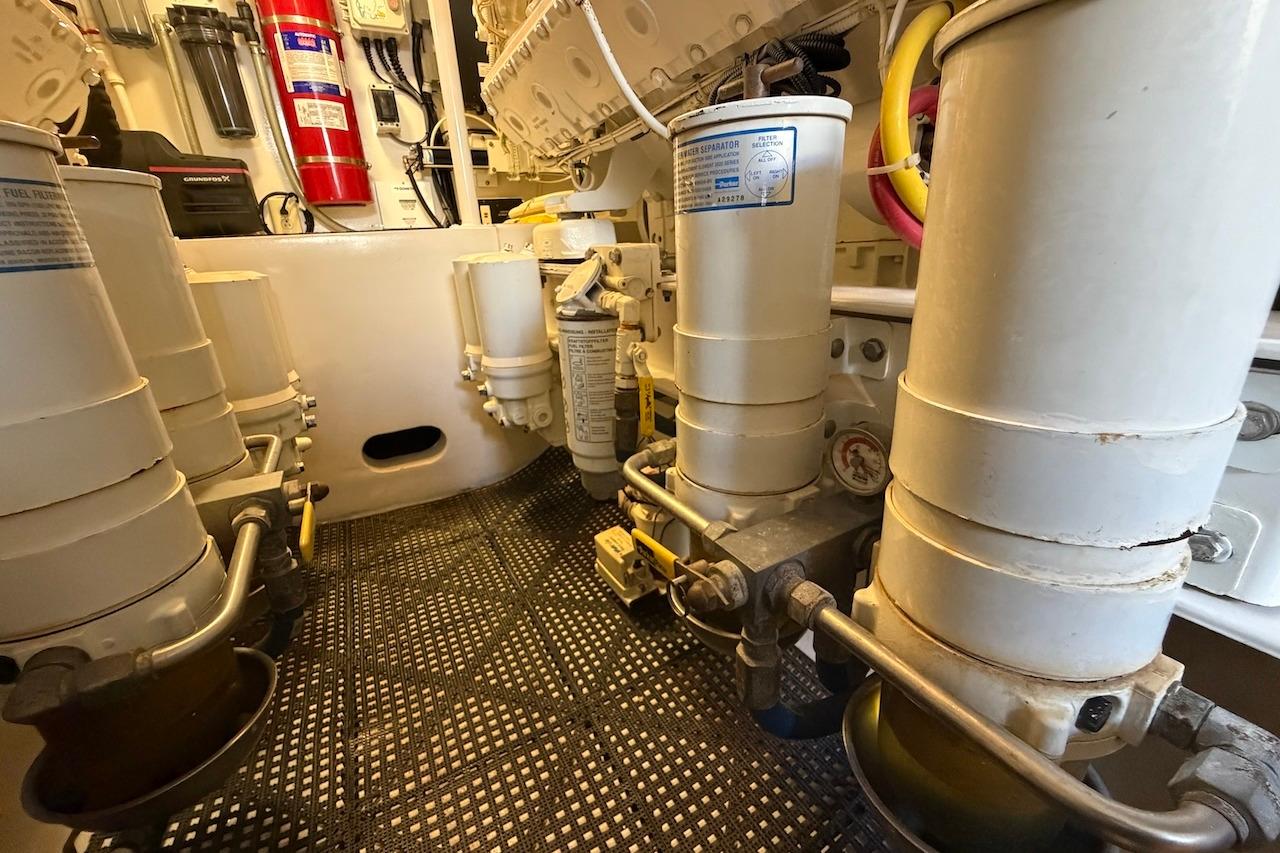 Engine room of a 2012 Viking 50 Convertible yacht, showcasing filters and equipment.