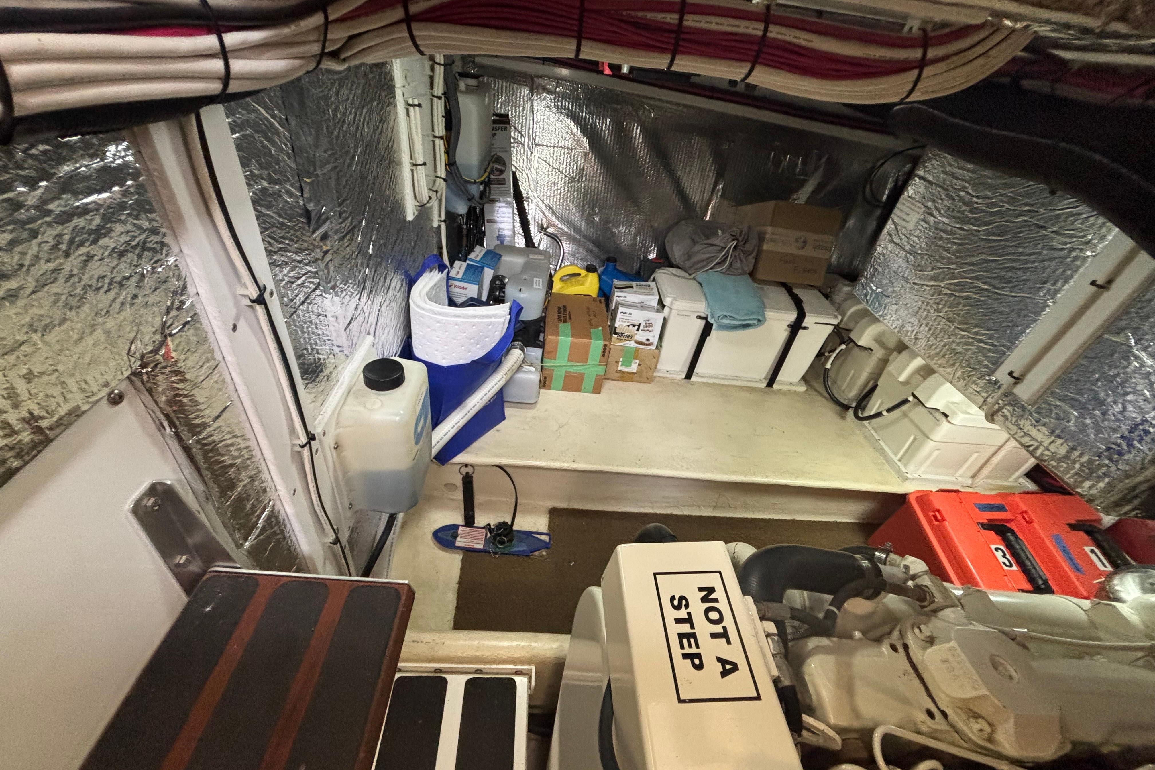 Engine room of a 2004 Nordic Tug 37, featuring organized storage and equipment.