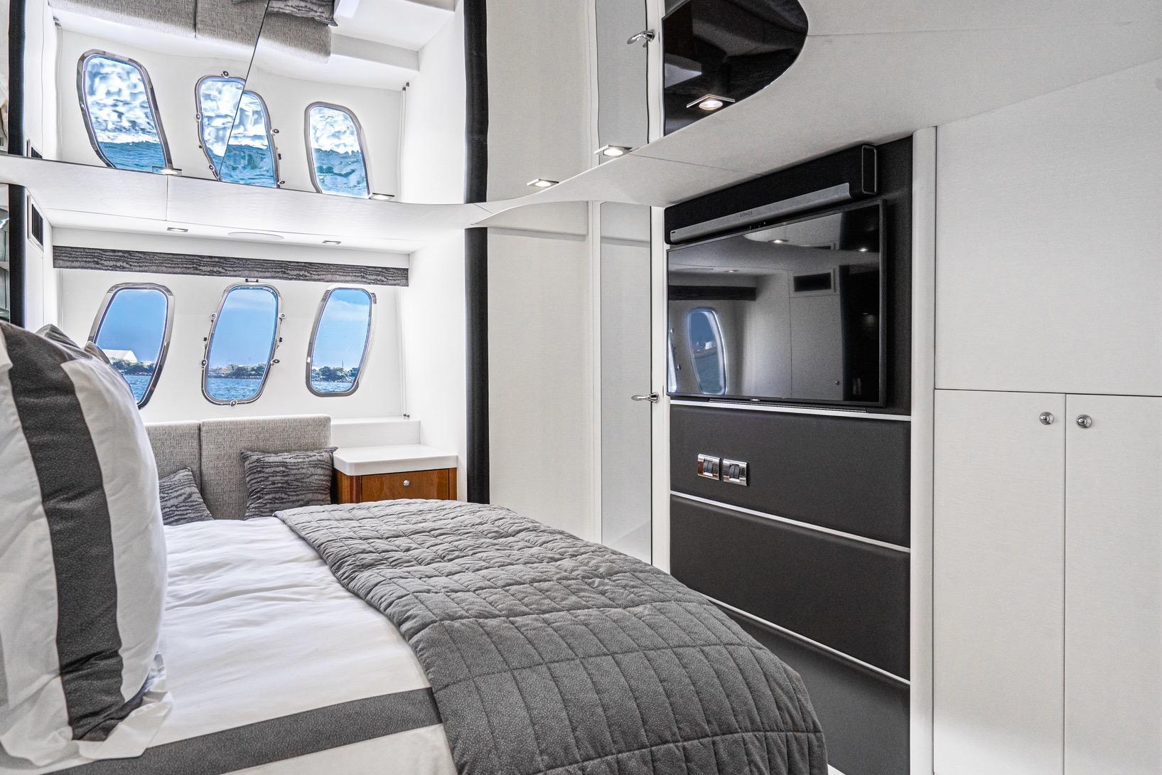 Luxurious interior of 2021 Sunseeker Predator 68 yacht bedroom with modern design.
