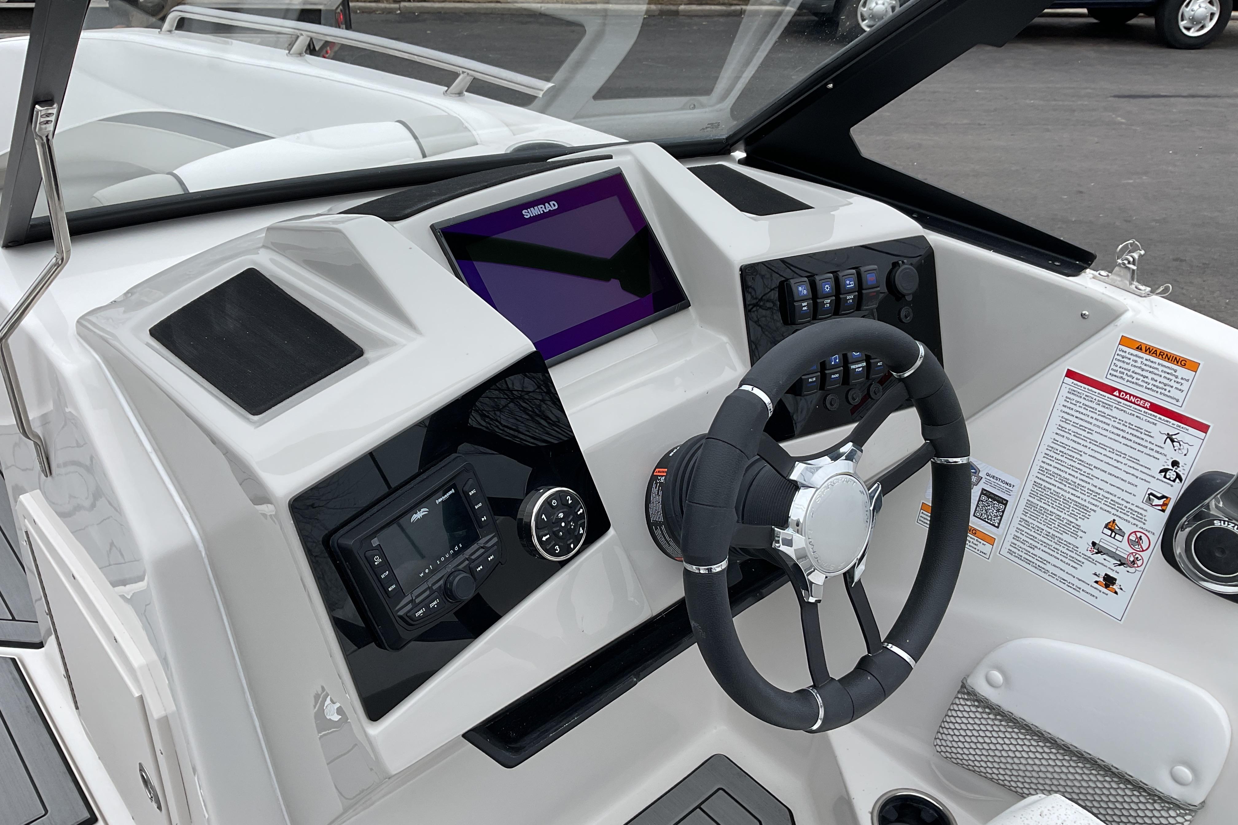 2026 Starcraft SVX 210 DC OB boat dashboard with steering wheel and control panel.