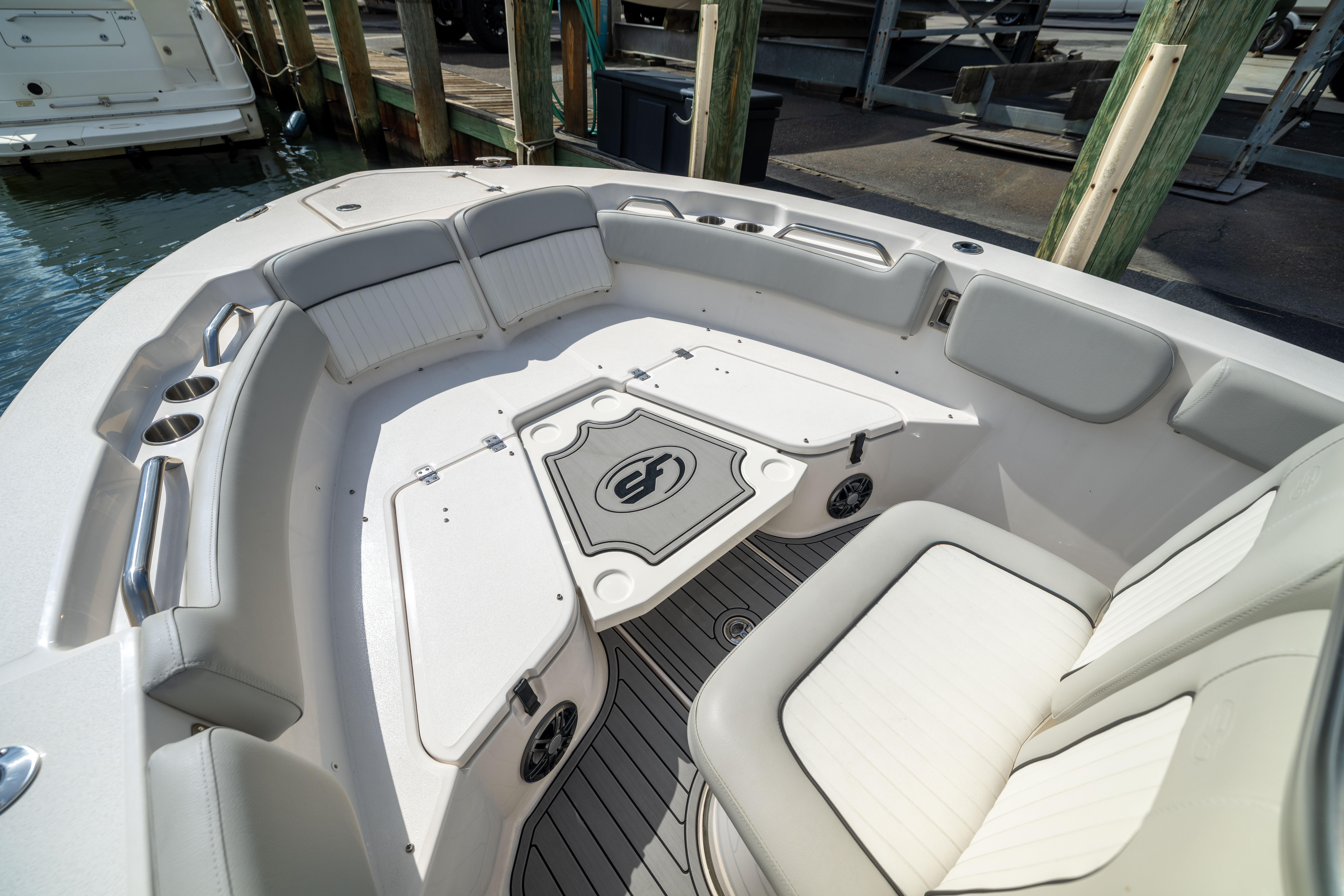 Interior view of 2023 Sea Fox 228 Commander boat with cushioned seating and storage.