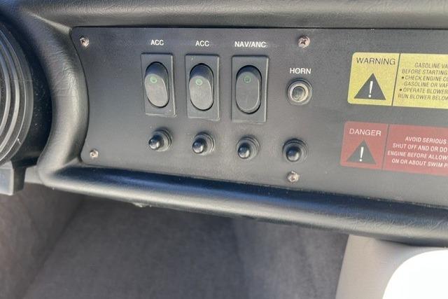 1996 MasterCraft ProStar 190 dashboard controls with warning labels and switches.