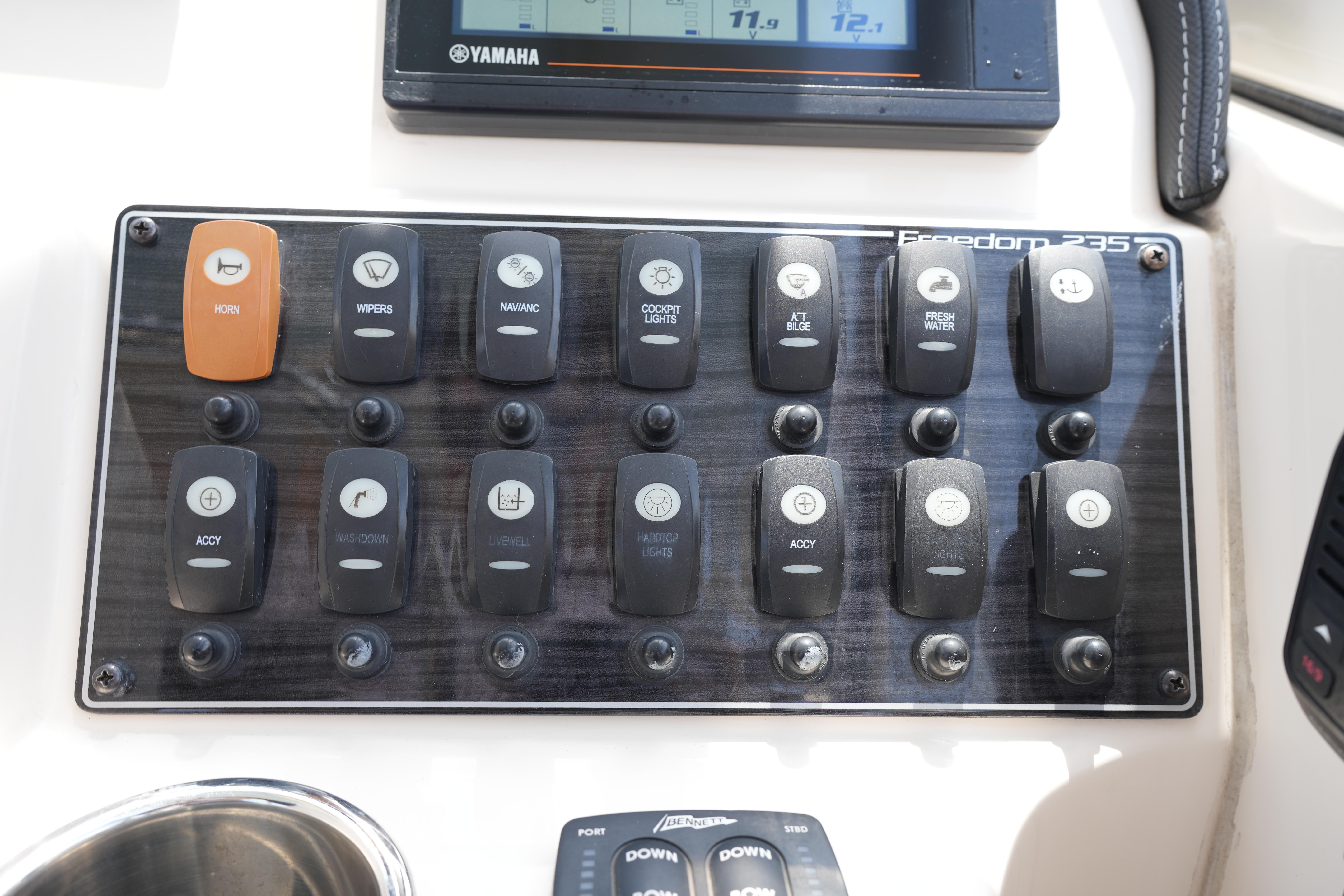 Control panel of 2021 Grady-White Freedom 235 boat with labeled switches and Yamaha display.
