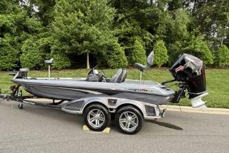 2026 Ranger Z519R Cup-Equipped boat on trailer, parked on road with lush greenery.