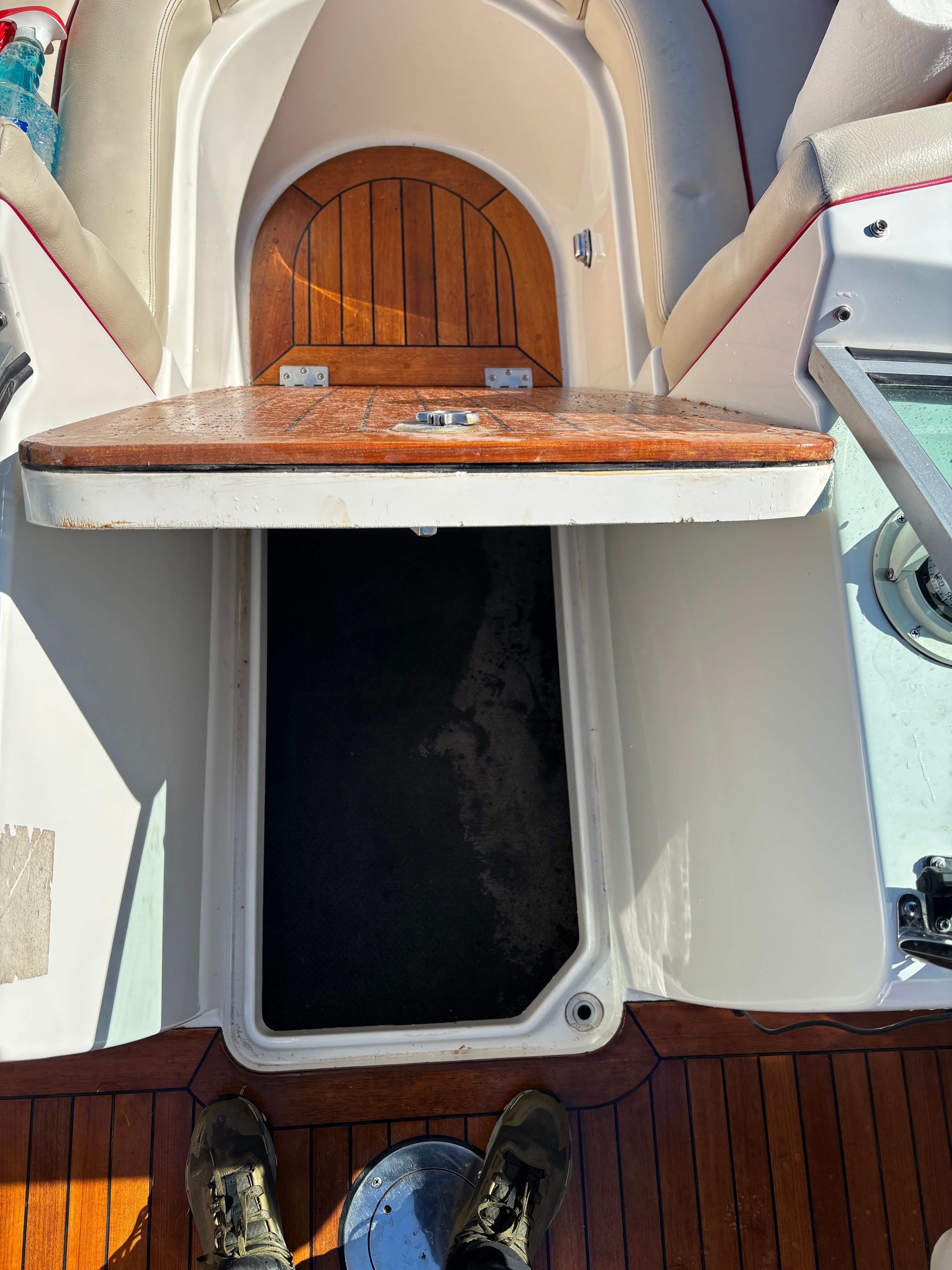 An open storage compartment on a 2003 Chris-Craft Launch 22 boat.