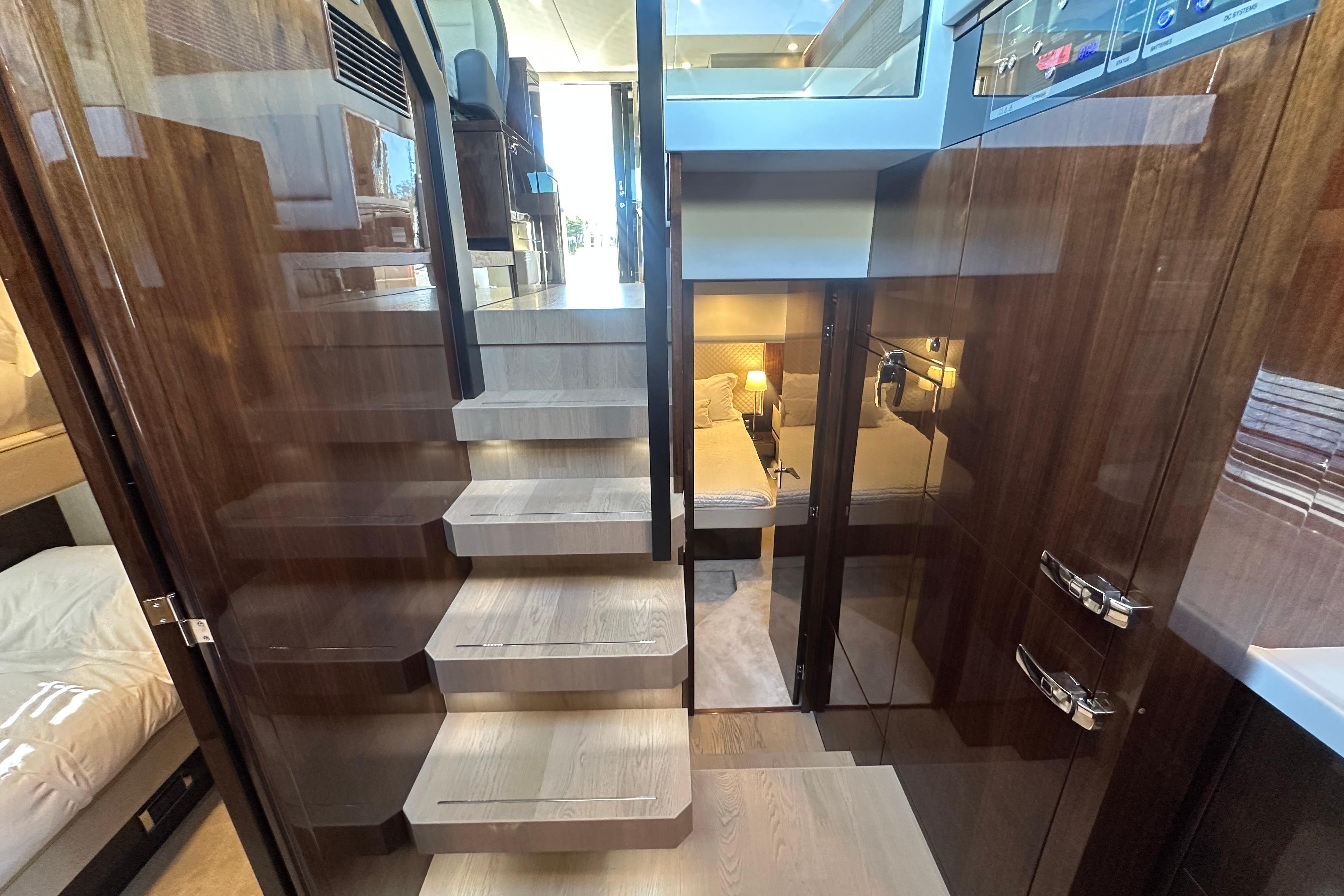 Luxurious interior of 2024 Fairline Squadron 50 yacht with elegant wooden staircase and modern design.