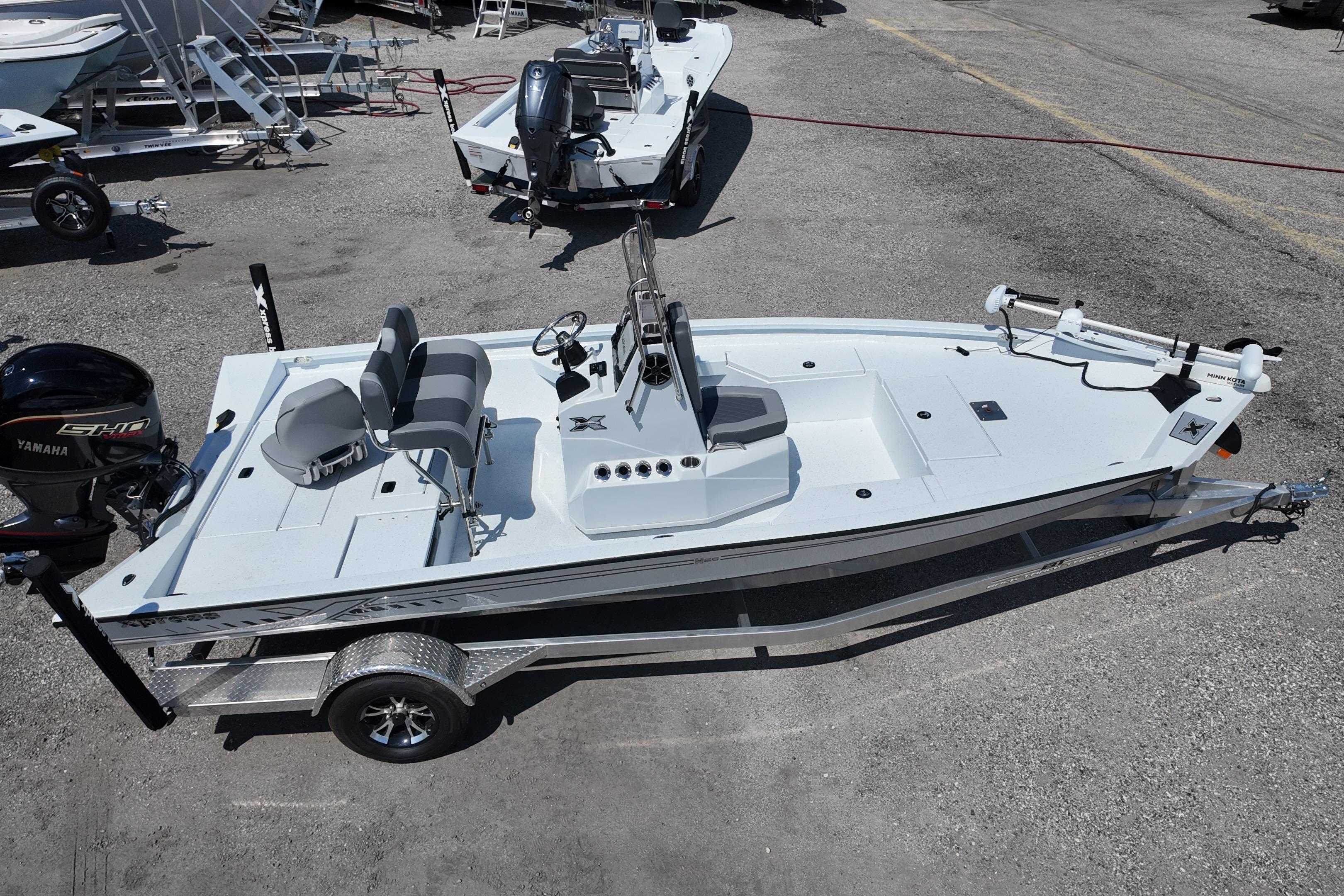 2026 Xpress H20 boat on trailer, featuring Yamaha engine, parked in a marina.