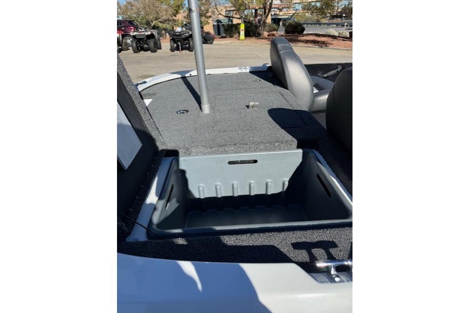 2026 Nitro Z17 boat interior with open storage compartment, gray seating, and outdoor setting.
