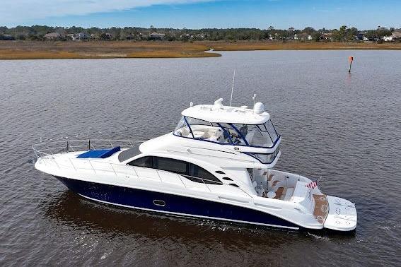 2006 Sea Ray 580 Sedan Bridge yacht cruising on calm waters.