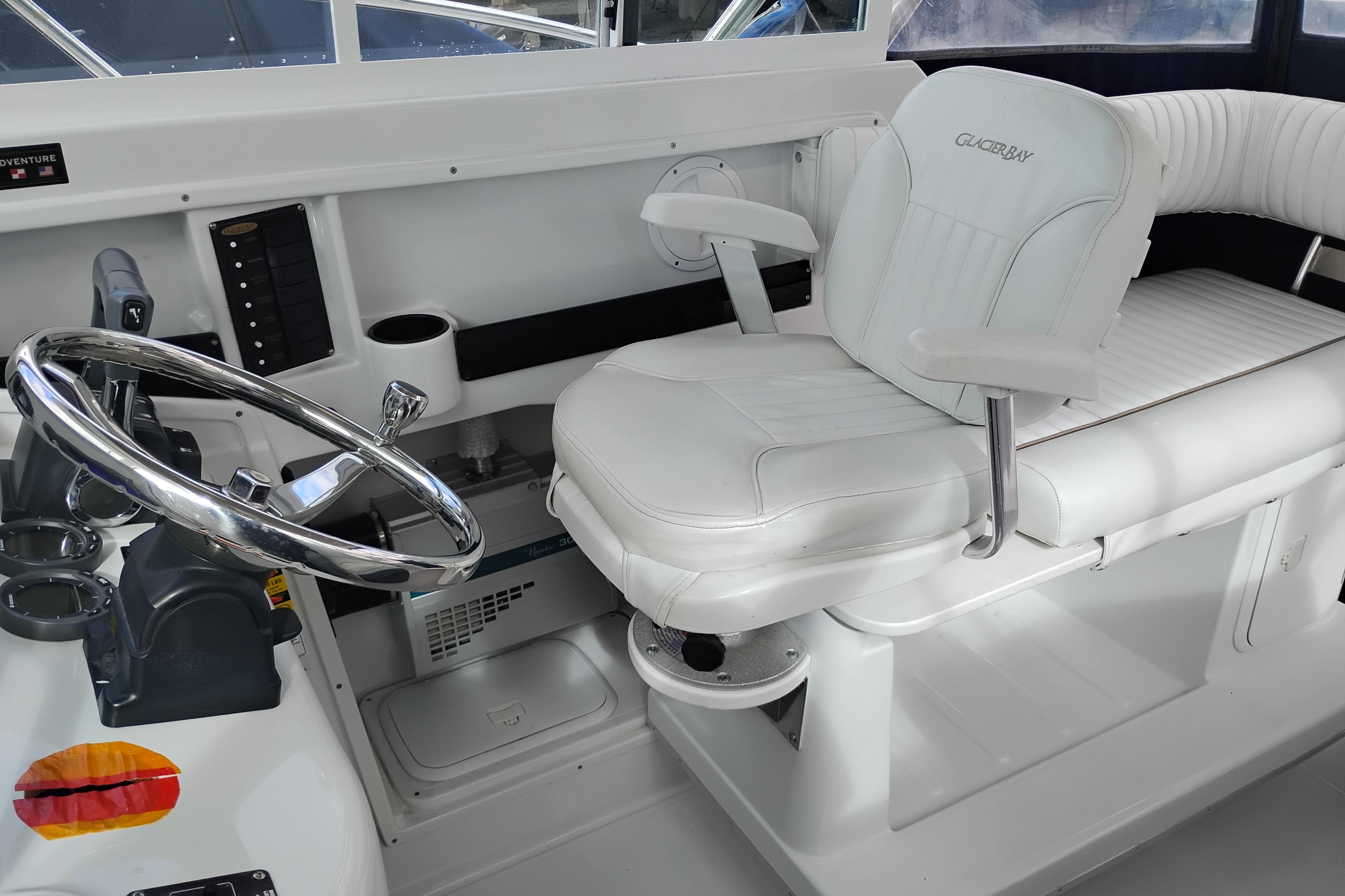 2007 Glacier Bay 2685 Coastal Runner helm with white captain's chair and steering wheel.