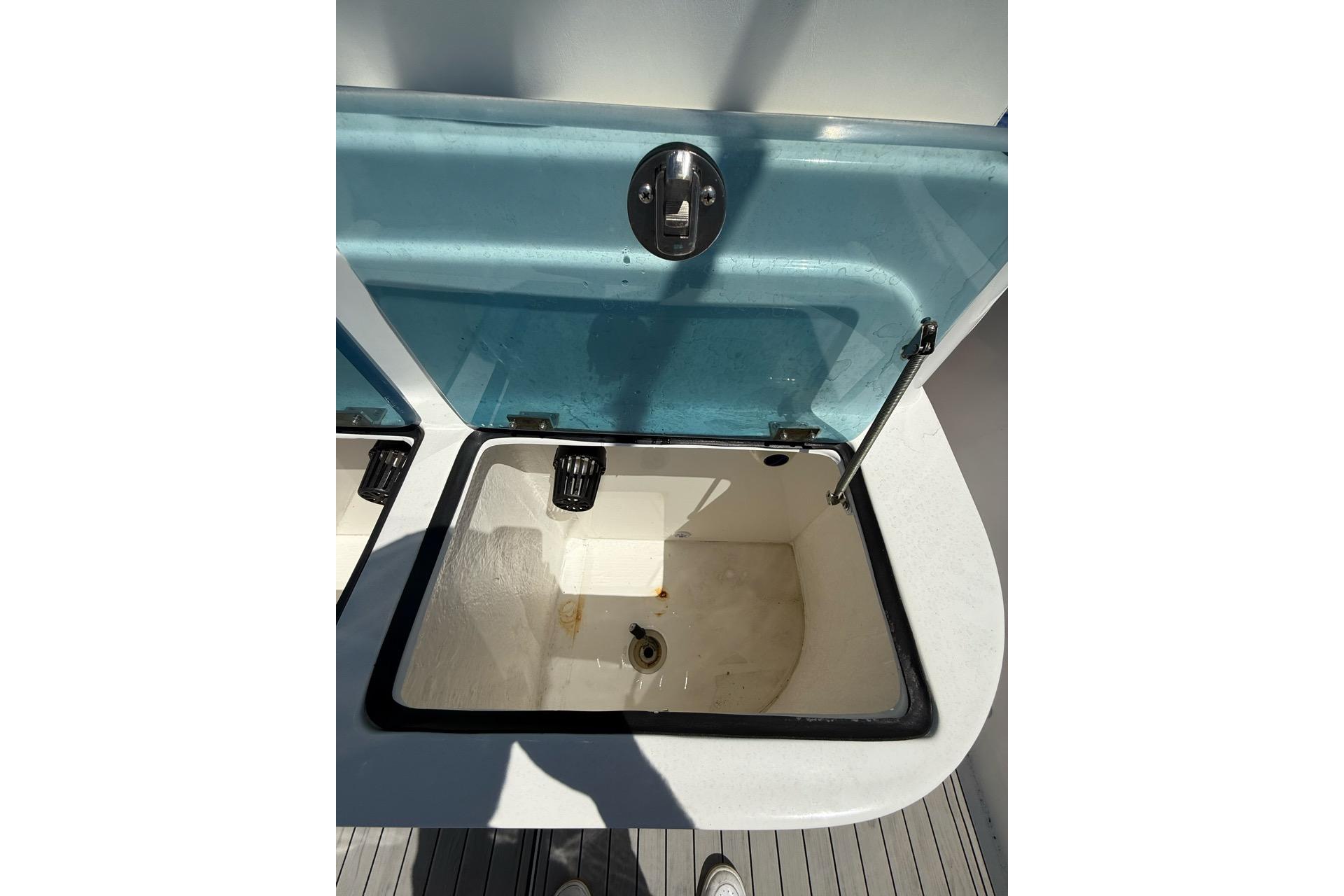 Open storage compartment on 2021 Custom Infusion 34 CC boat, featuring a blue lid.
