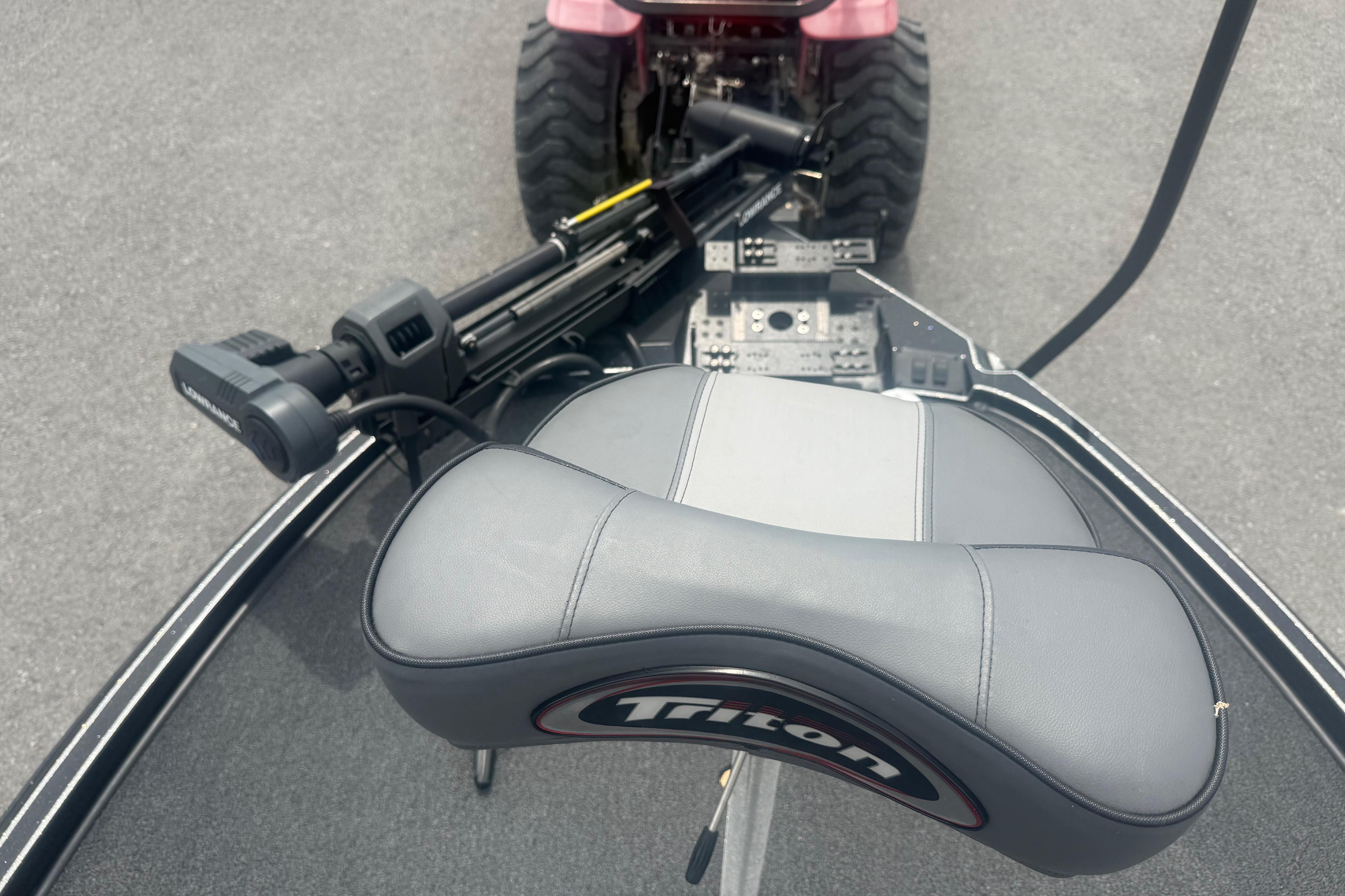 2024 Triton 20XP boat seat and control panel with trolling motor on deck.
