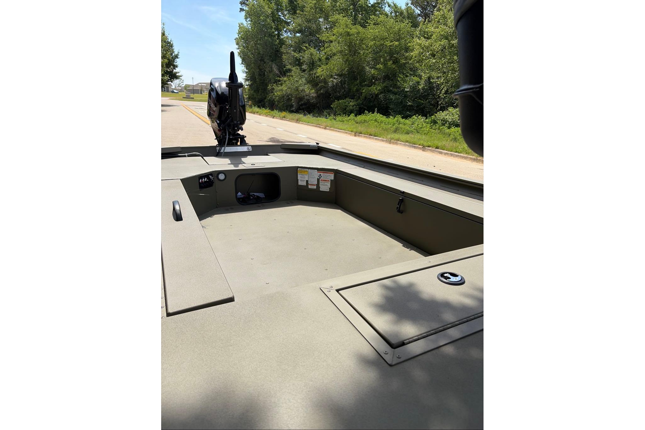 2026 Tracker Grizzly 1654 T Sportsman boat interior, featuring spacious deck and storage compartments.
