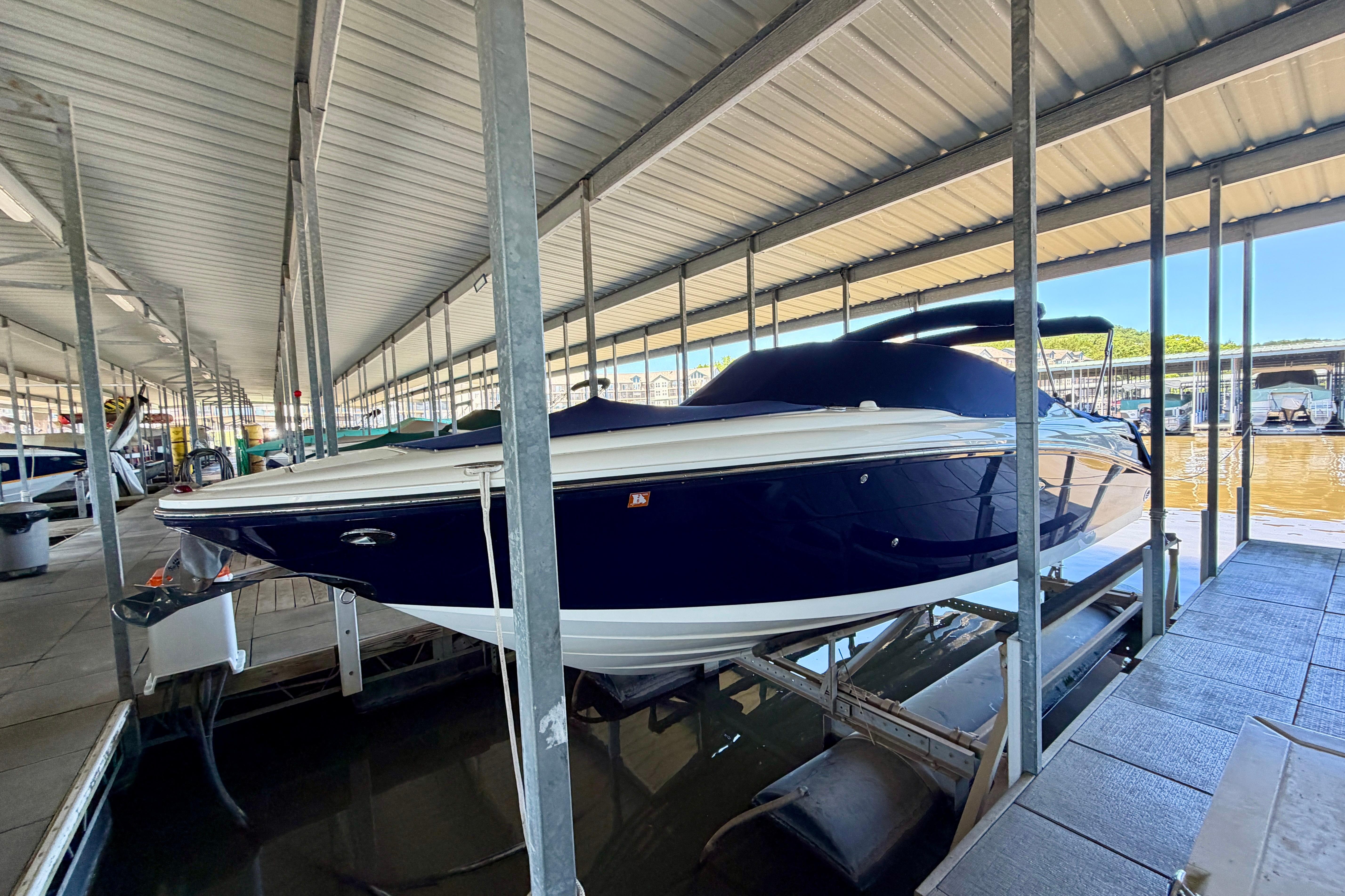 2007 Sea Ray 270 SLX boat docked in a covered marina.