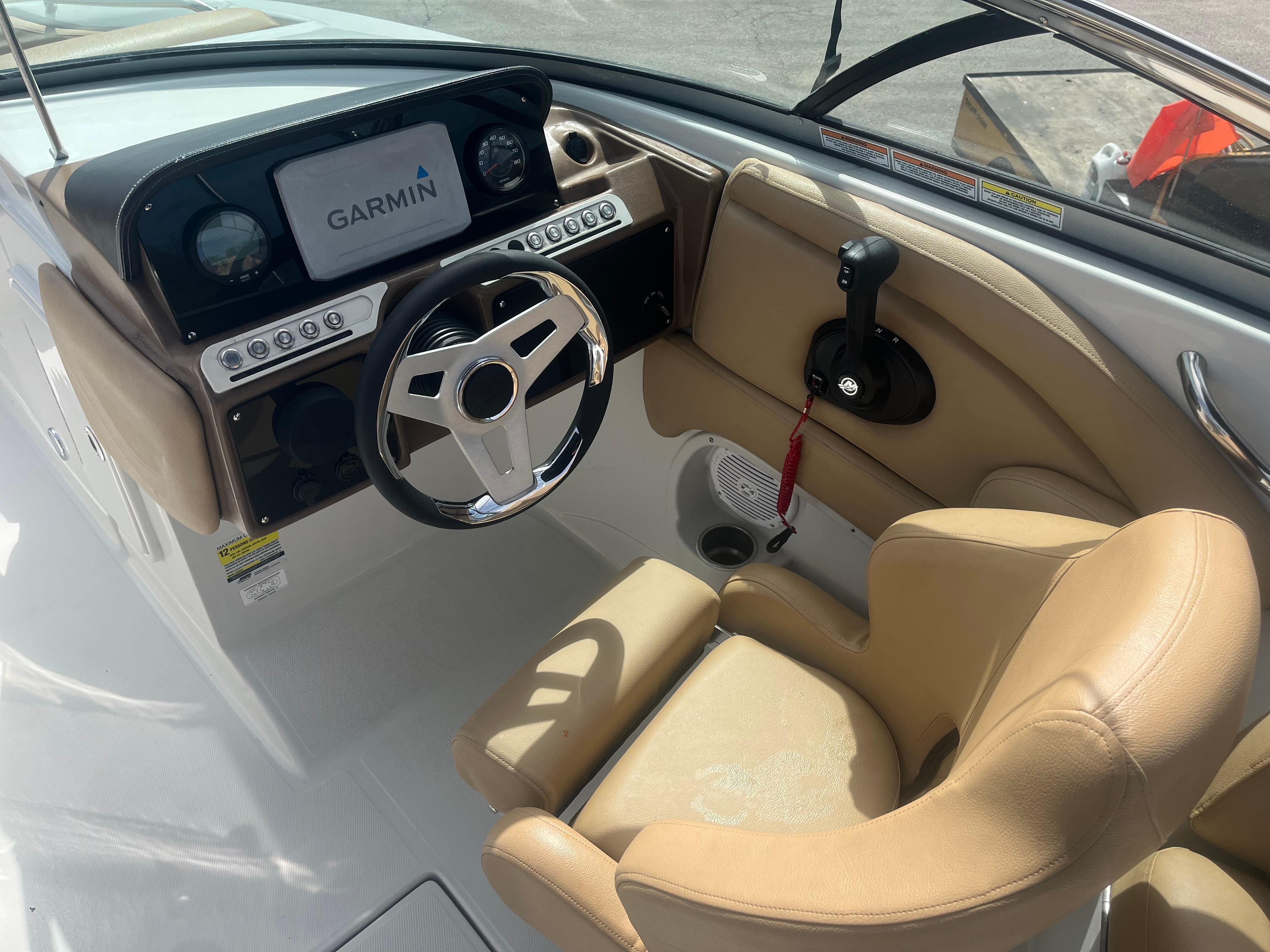 2022 Crownline Eclipse E235 XS boat cockpit with Garmin display and beige seating.