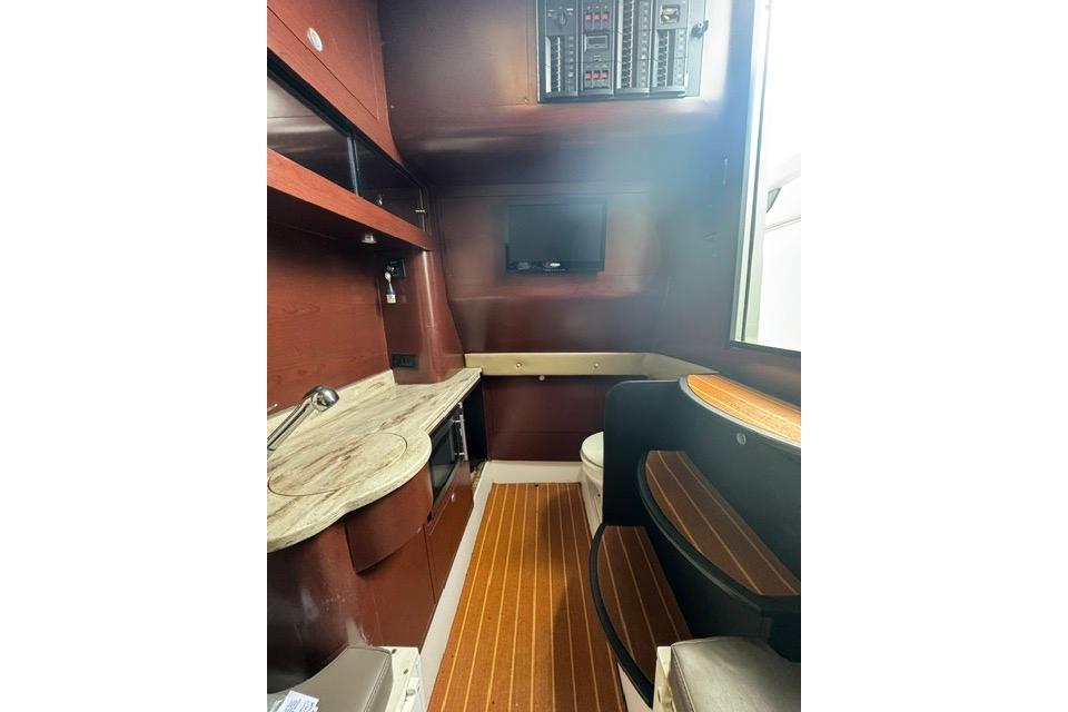 Interior of 2016 Mystic M4200 boat with wood accents and modern amenities.