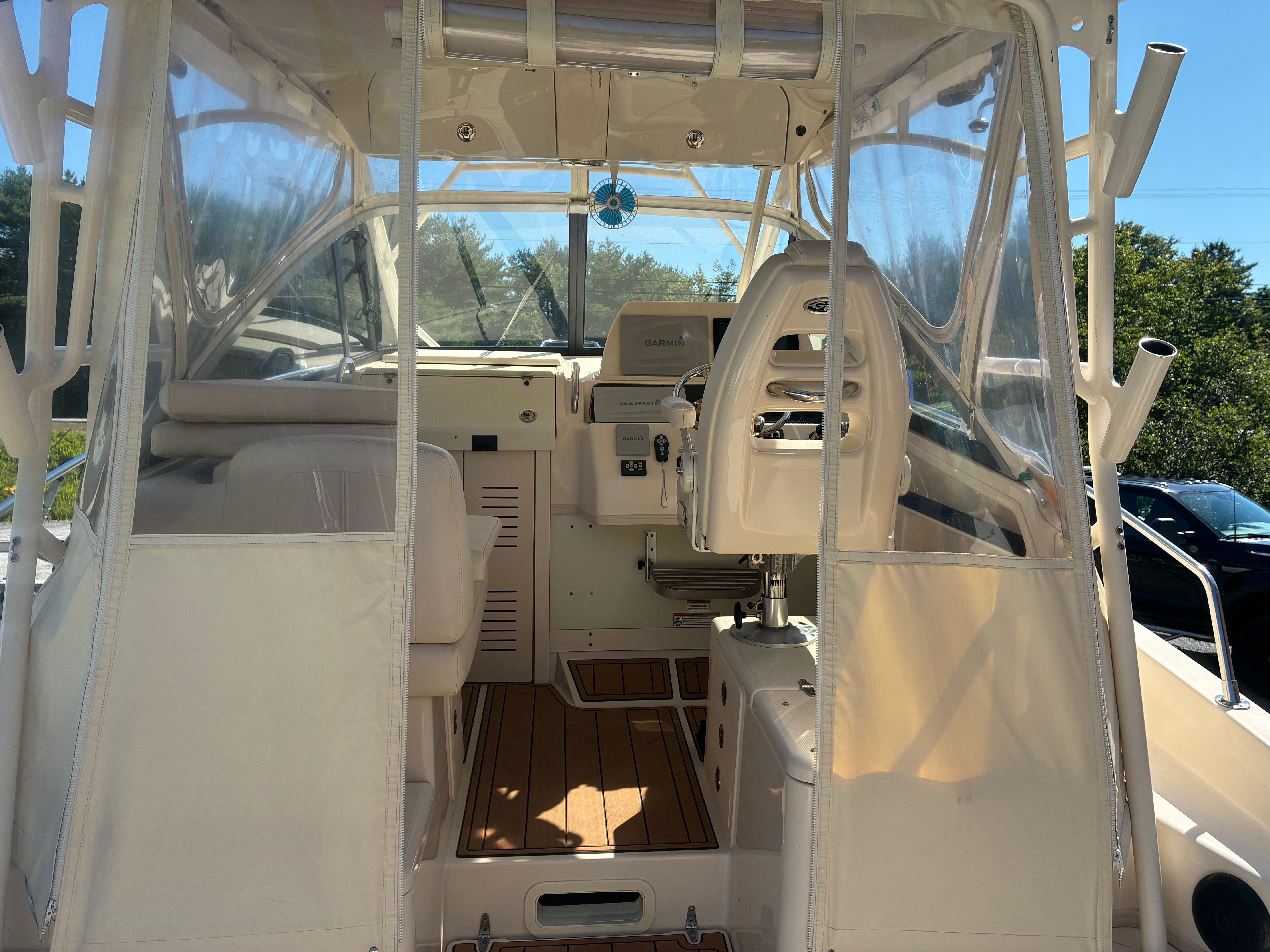 The image shows the cockpit of a 2017 Grady-White Marlin 300 with clear covers.