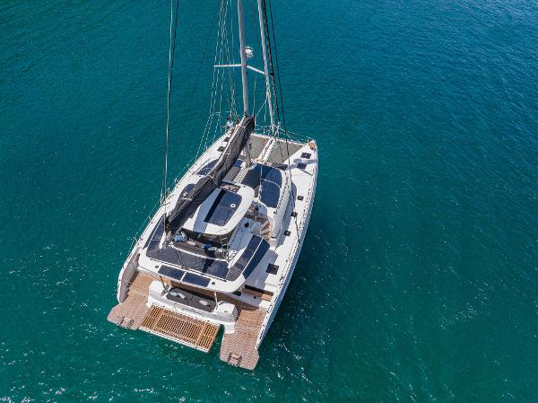 2025 Lagoon 51 ICONIC catamaran sailing on clear blue water.