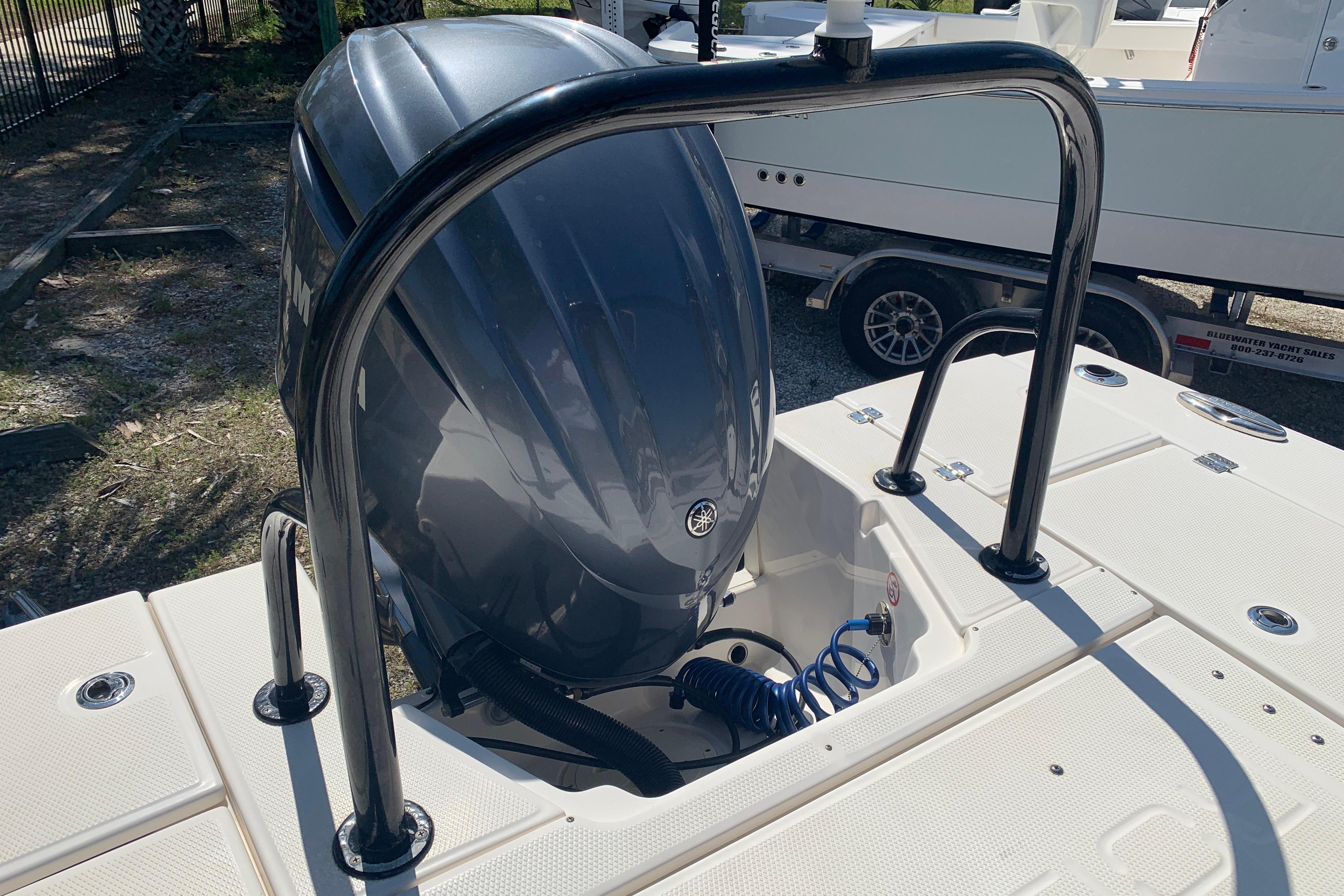 2022 Robalo 246 Cayman boat engine with protective railing, parked on a trailer.