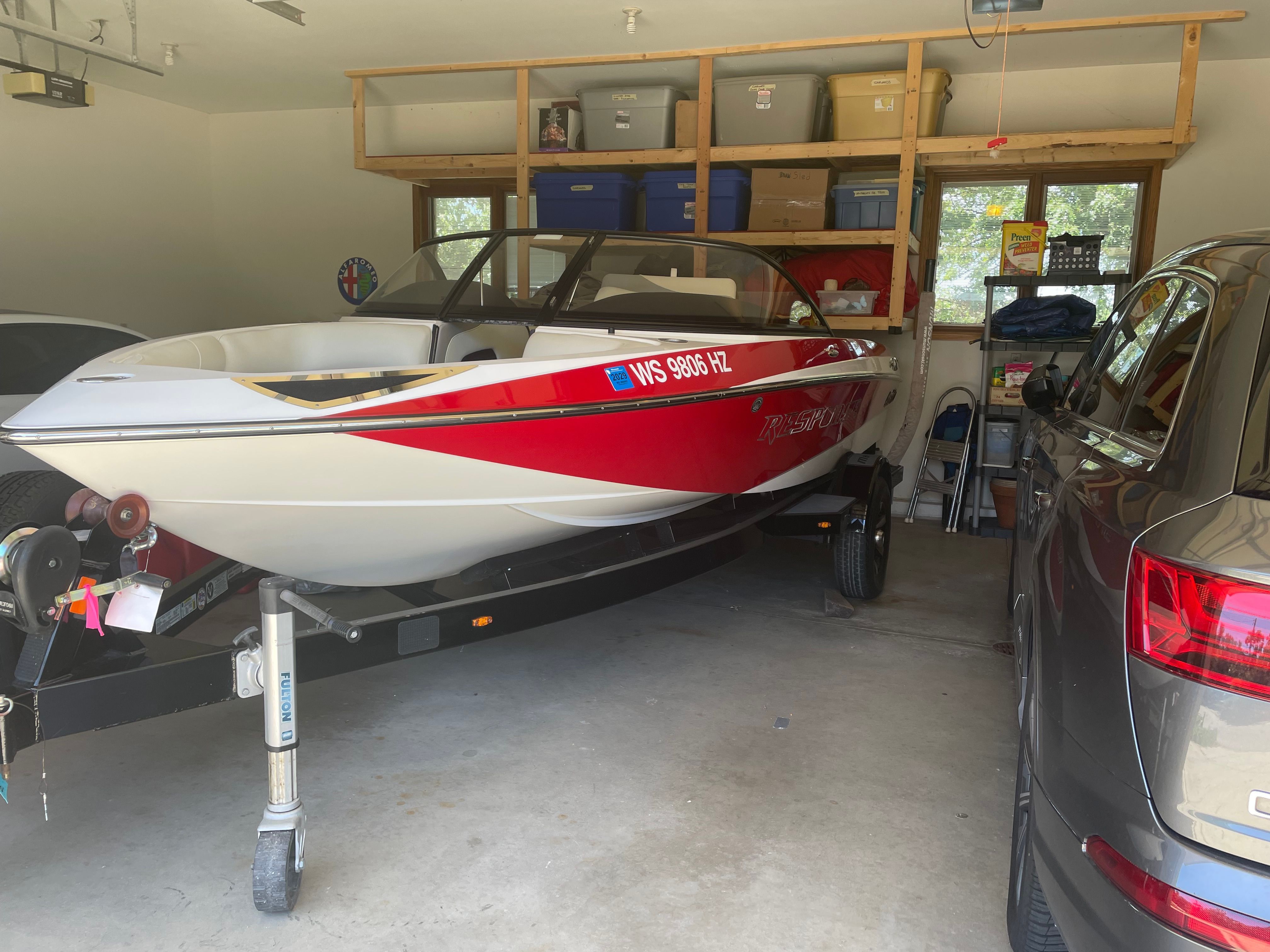 2014 Malibu Response TXi boat parked in a garage.