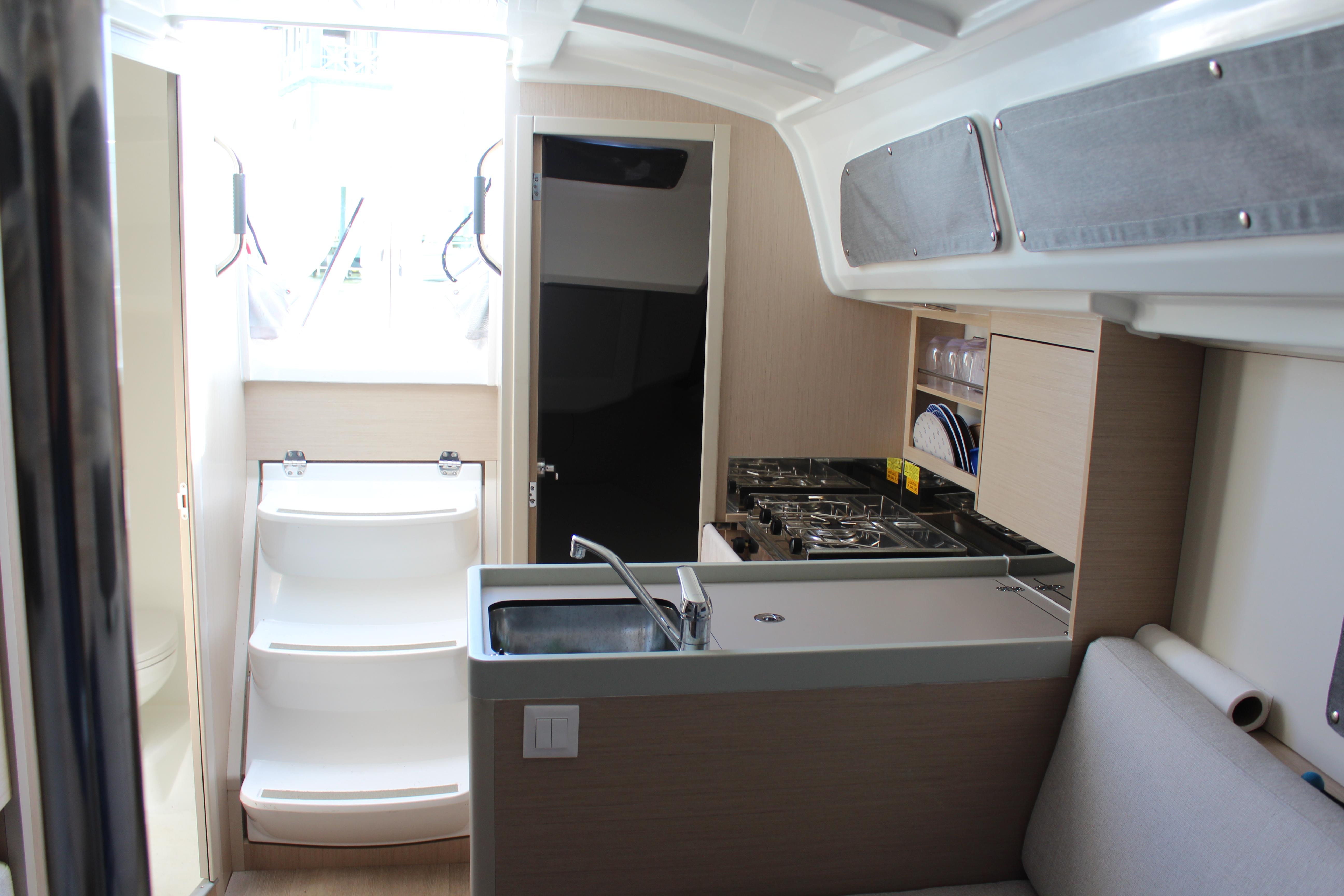 Interior of 2022 Beneteau Oceanis 30.1 yacht, featuring modern kitchen and compact design.