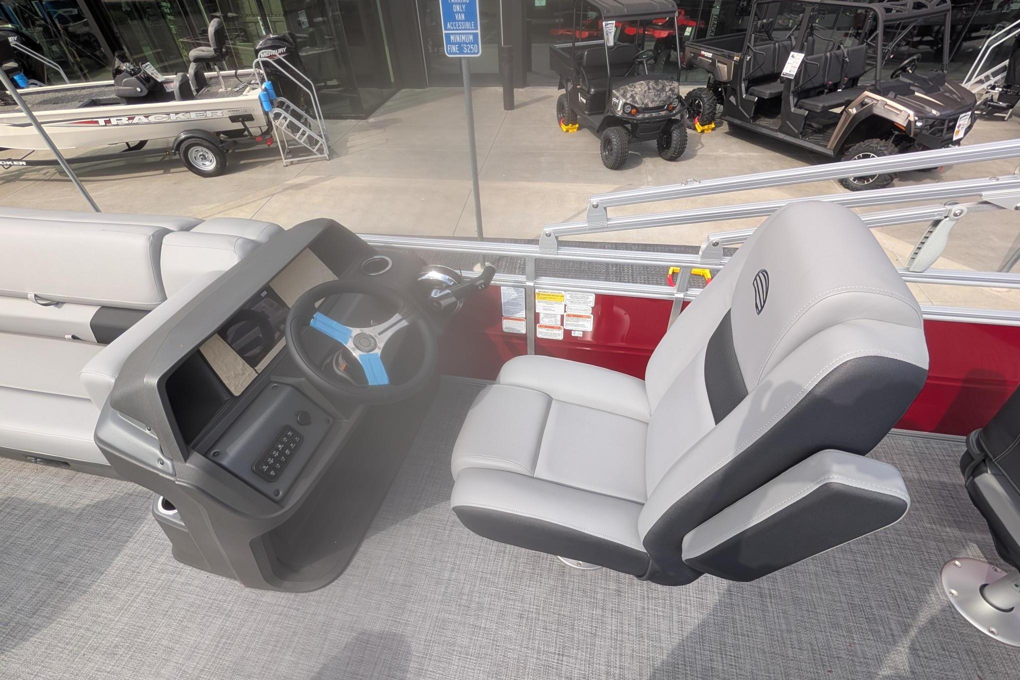 2026 Sun Tracker SportFish 20 DLX boat interior with steering console and comfortable seating.