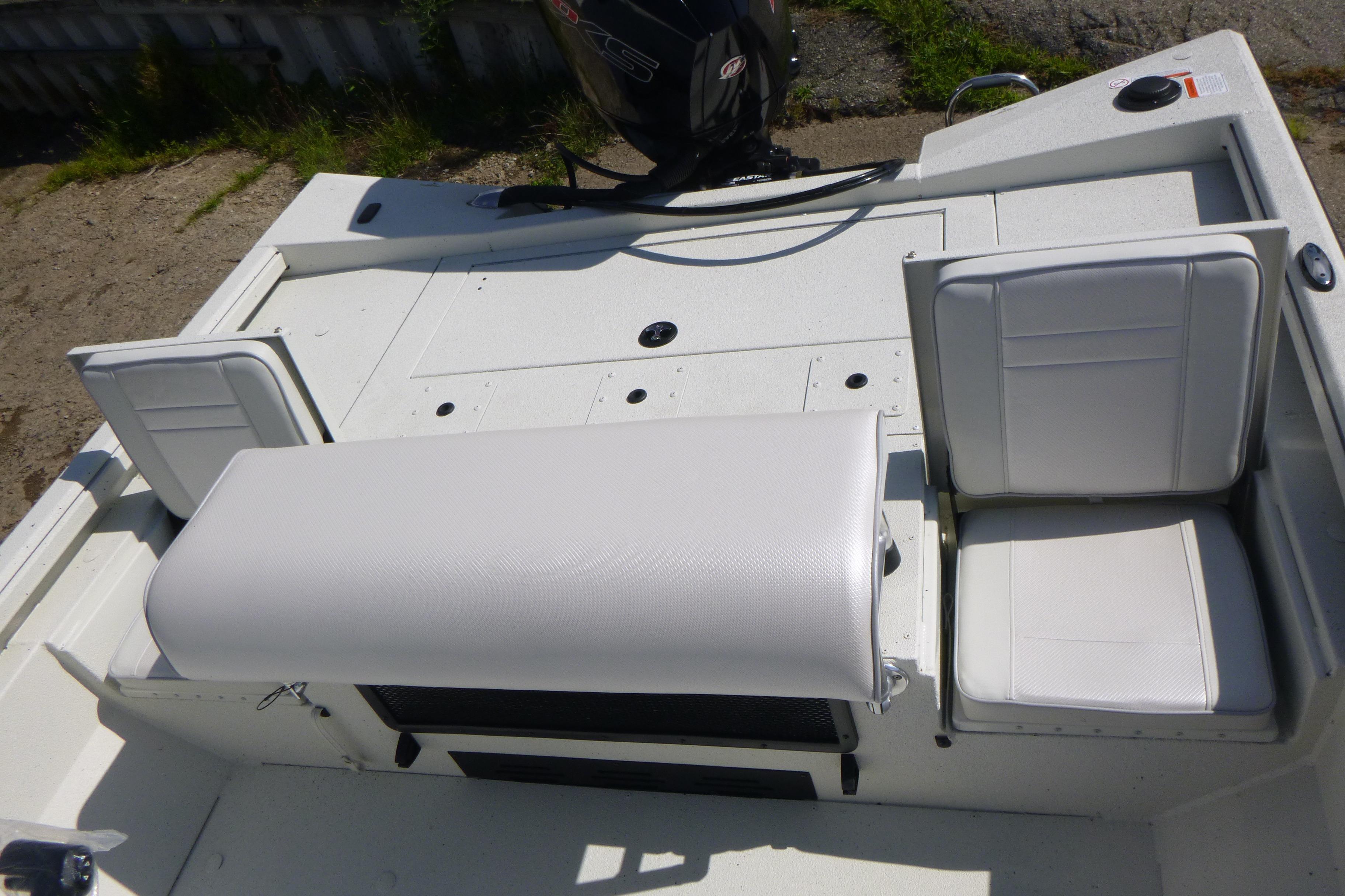 2025 Ranger RB210 boat interior with white seating and motor, viewed from above.