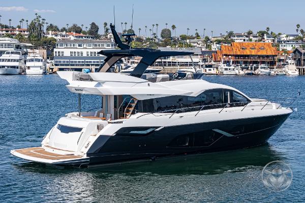 2025 Sunseeker Manhattan 68 luxury yacht on a scenic waterfront.