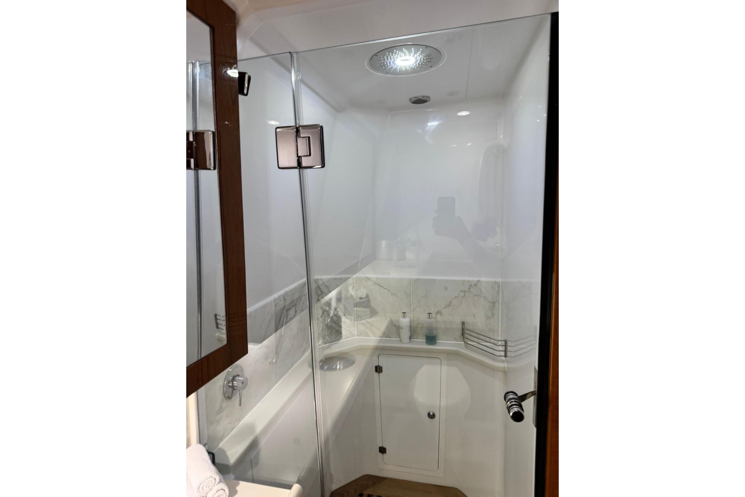 Luxurious bathroom interior of 2022 HCB 65 Estrella yacht with modern fixtures.