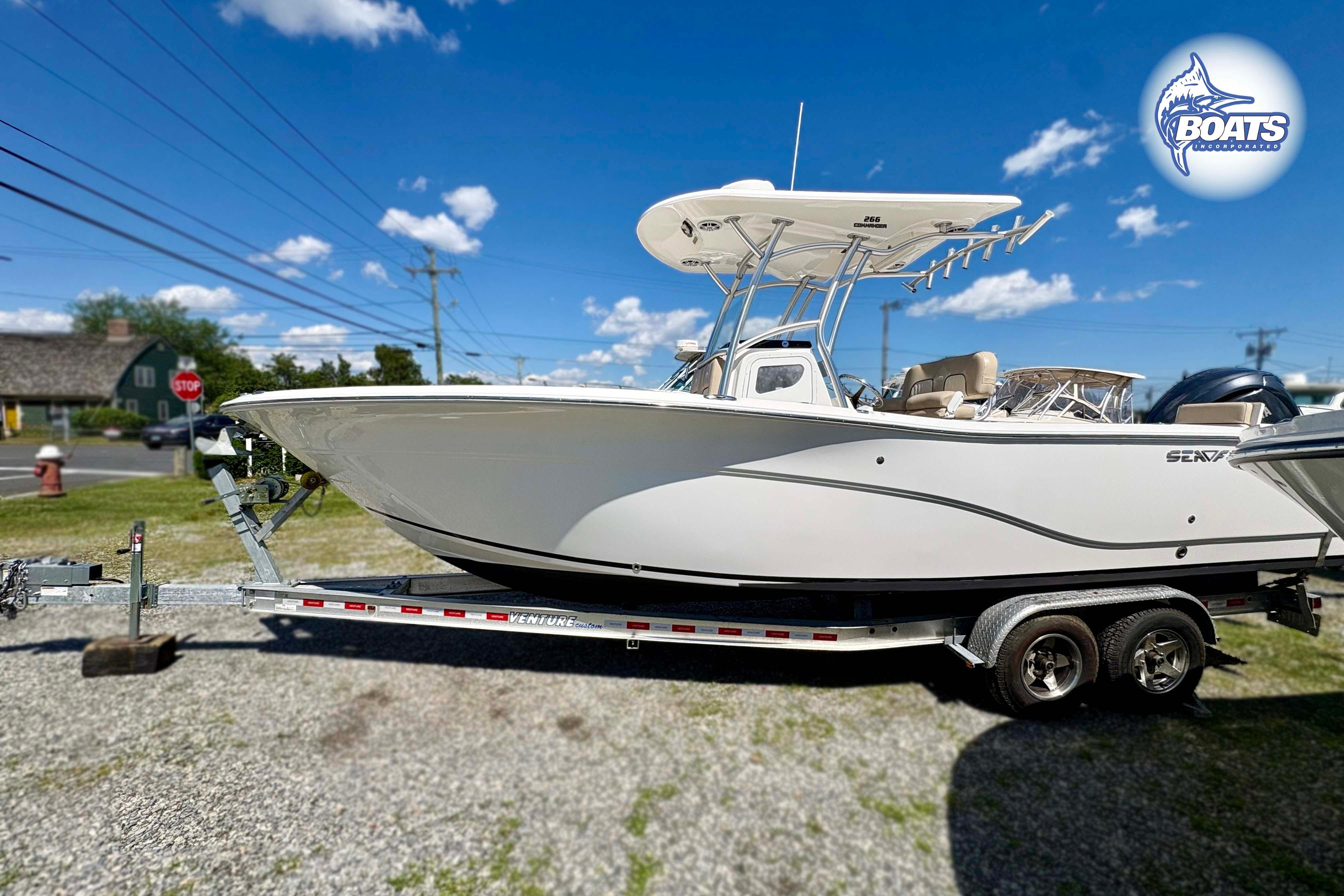 2015 Sea Fox 266 Commander boat on trailer under clear blue sky.
