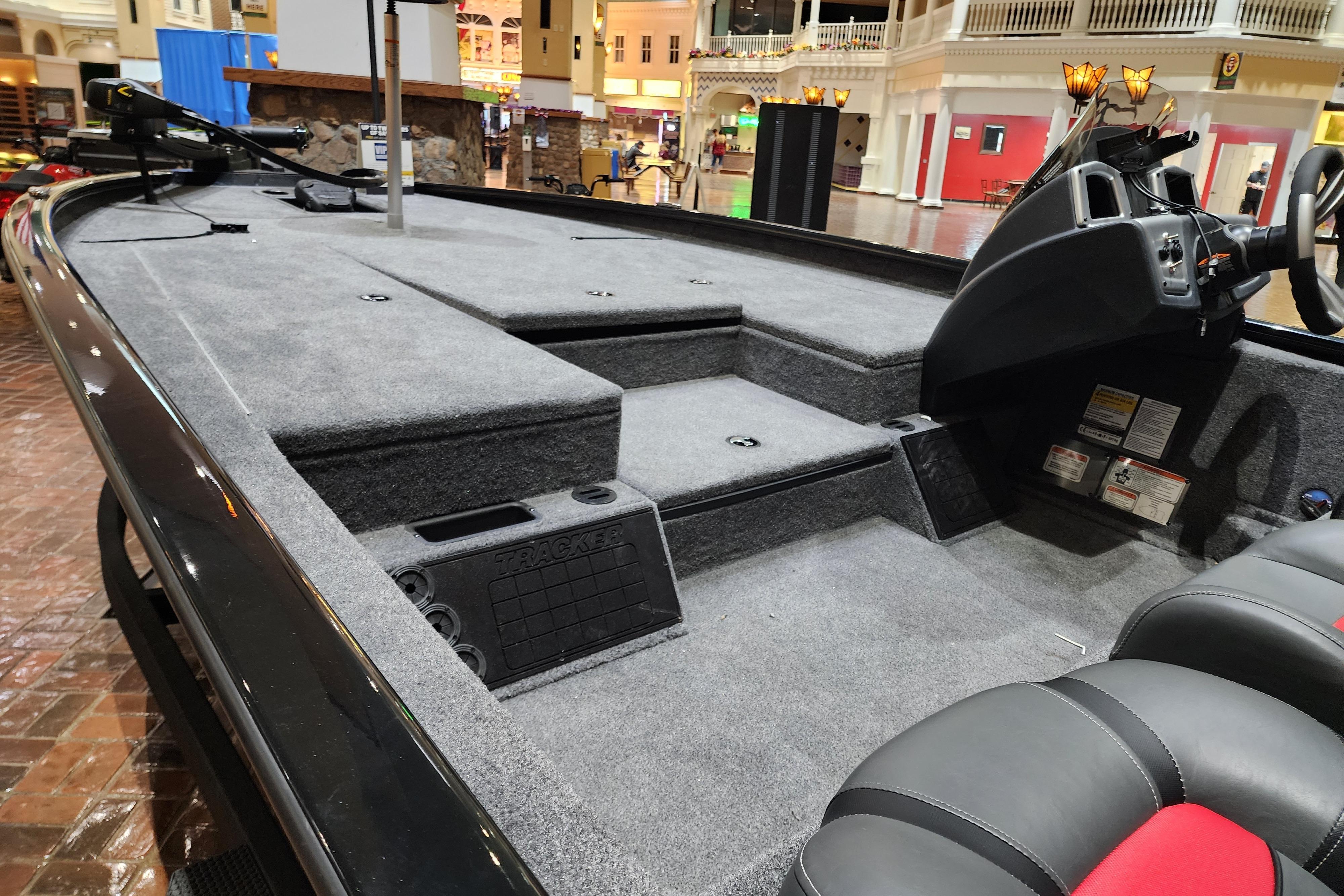 2025 Tracker Savage 215 boat interior with carpeted deck and modern console.