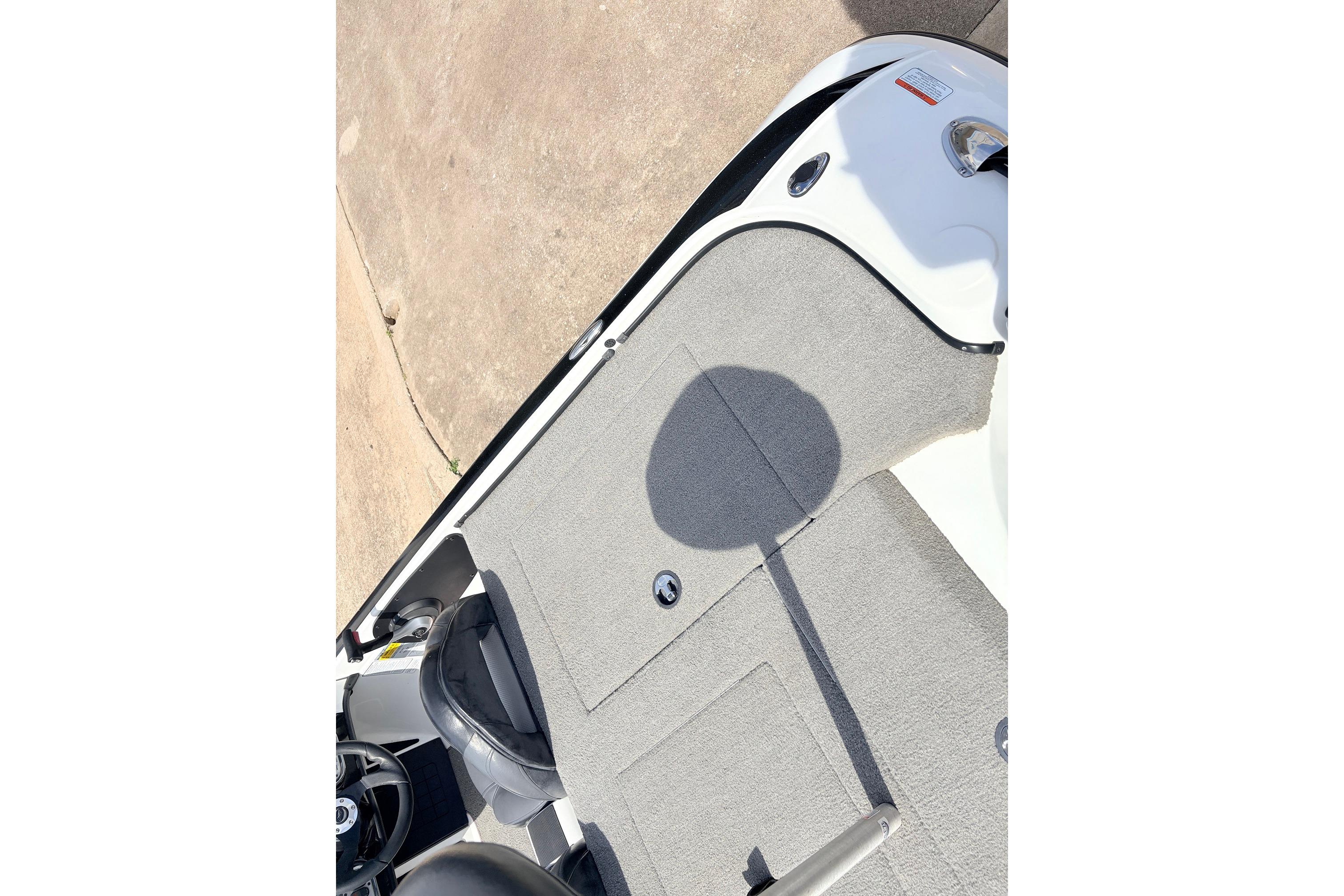 2011 Nitro Z-7 boat interior with gray carpet and steering wheel.
