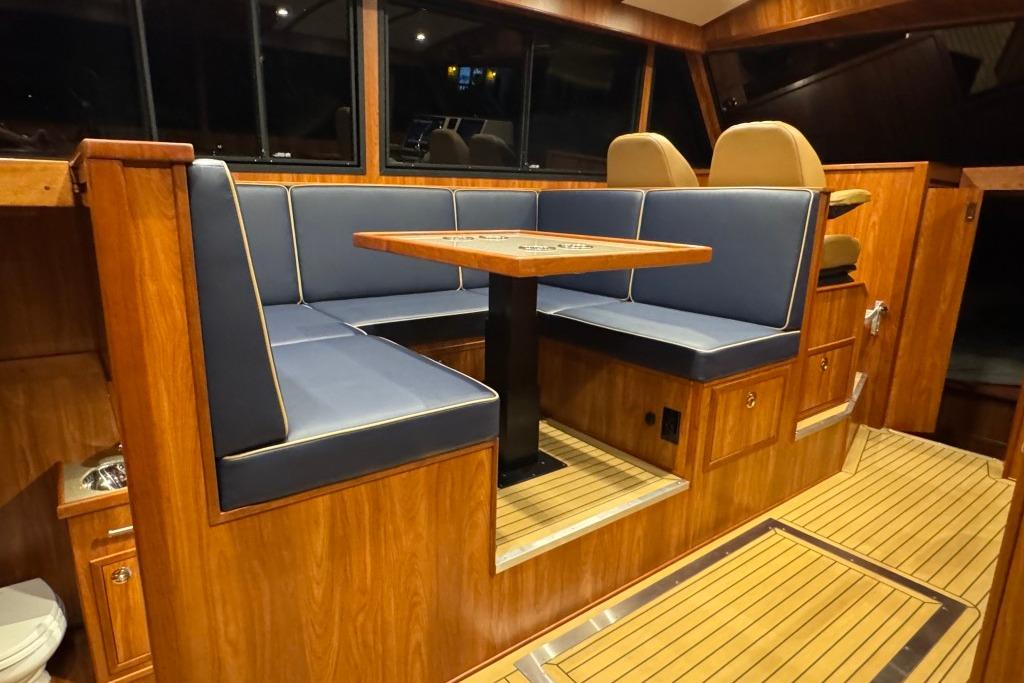 Luxurious interior of 2026 EagleCraft 42' Cruiser with wood finish and blue seating.