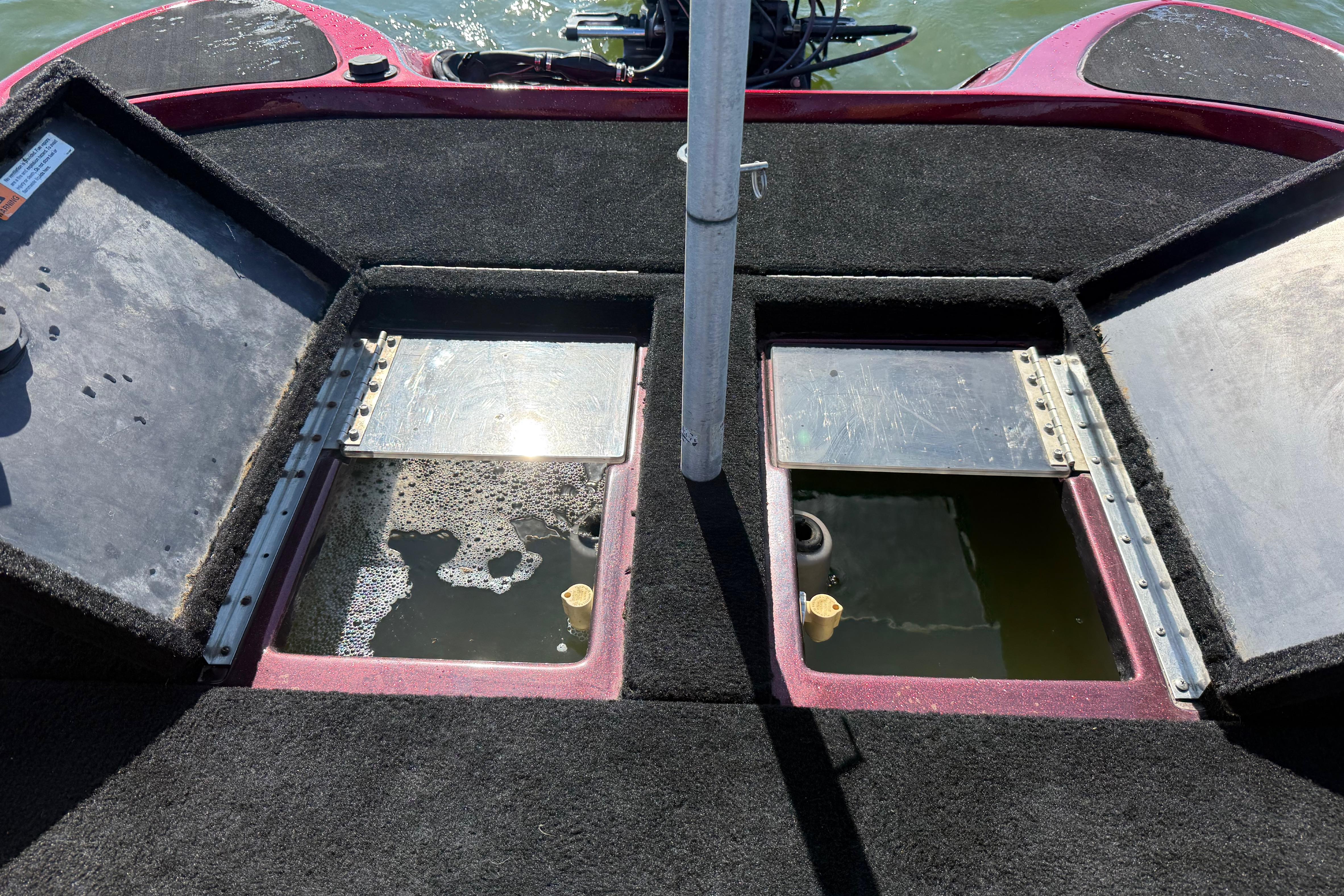 Open storage compartments on a 2000 Stratos 20SS Extreme boat deck.