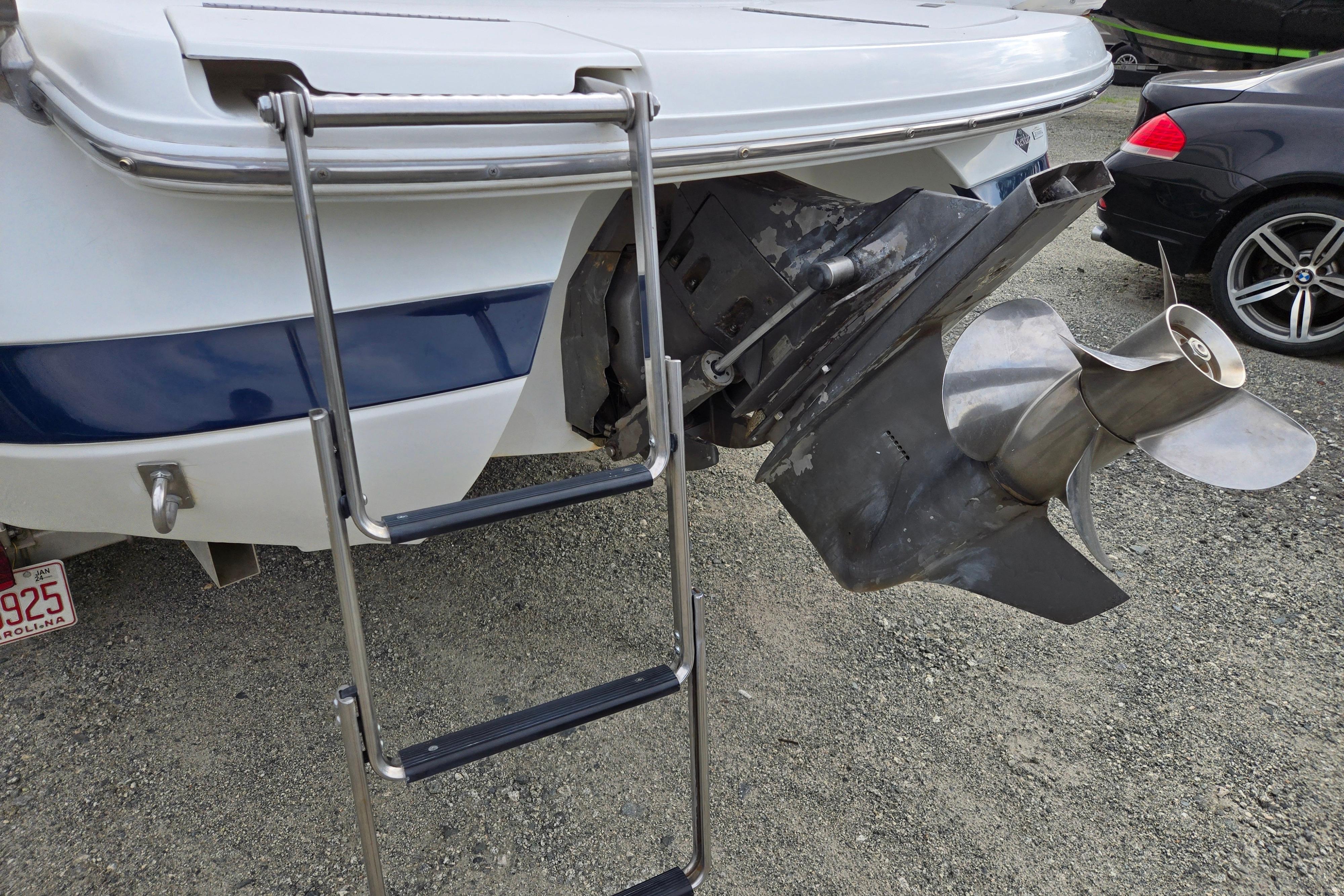 Rear view of a 2000 Cobalt 246 boat with ladder and propeller.