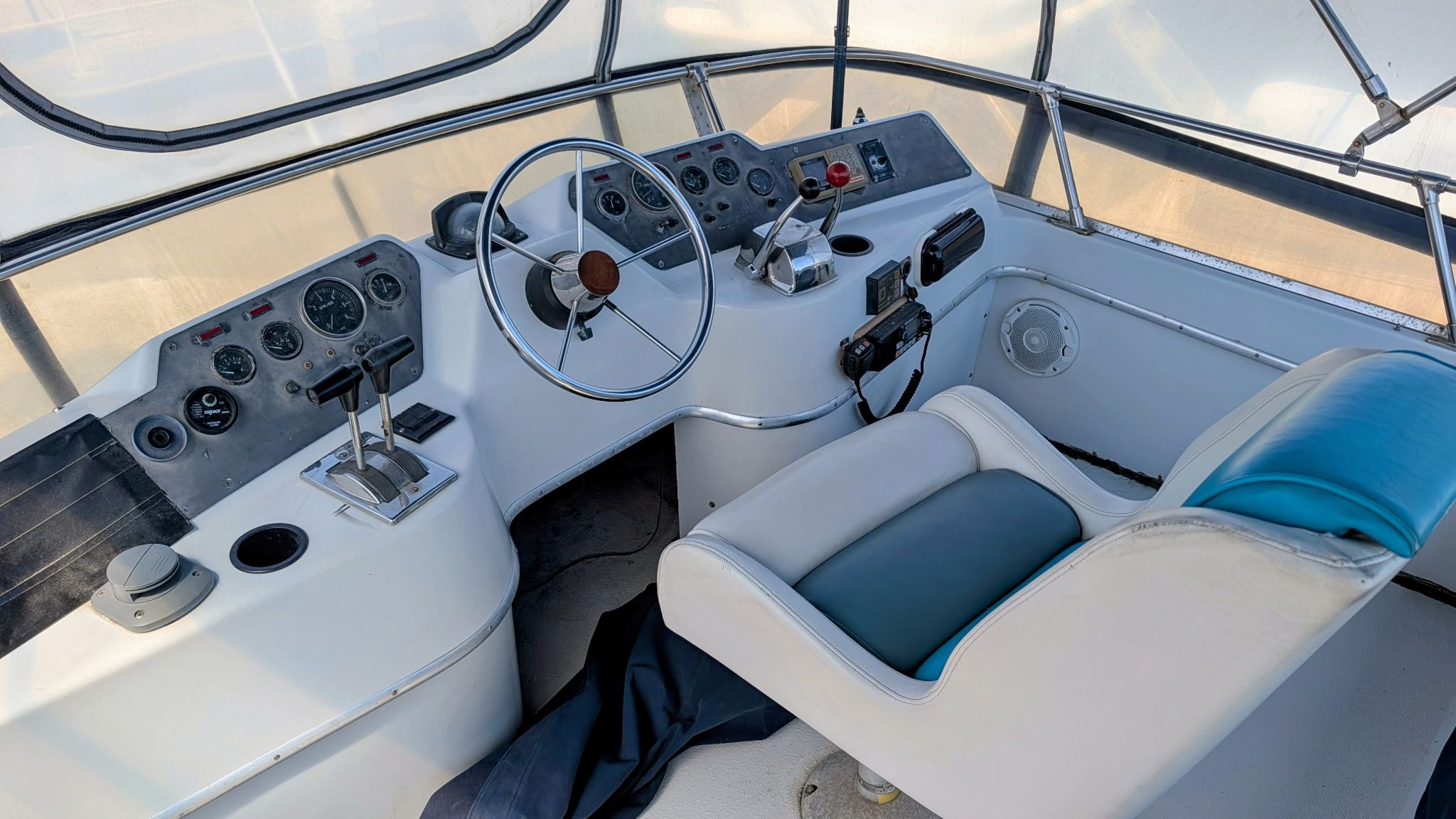 The image shows the cockpit of a 1987 Chris-Craft 320 Amerosport Express with steering wheel and instruments.