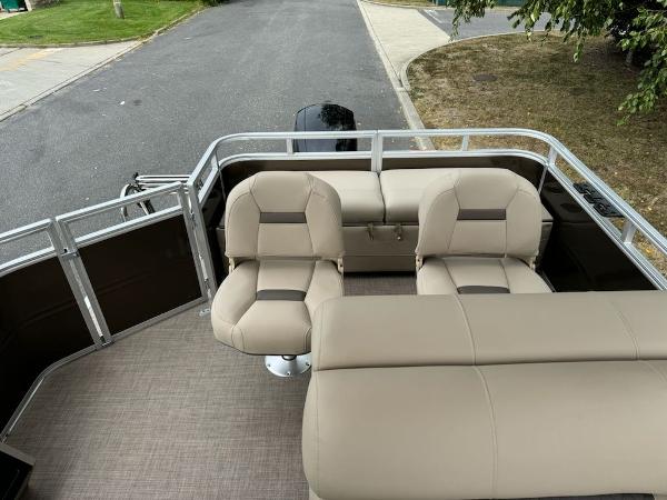 2025 Sun Tracker SportFish 22 XP3 boat interior with beige seating and spacious deck.
