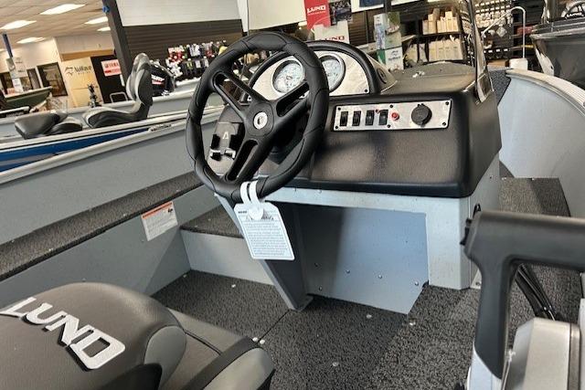2027 Lund 1600 Fury SS boat interior with steering wheel and dashboard controls.