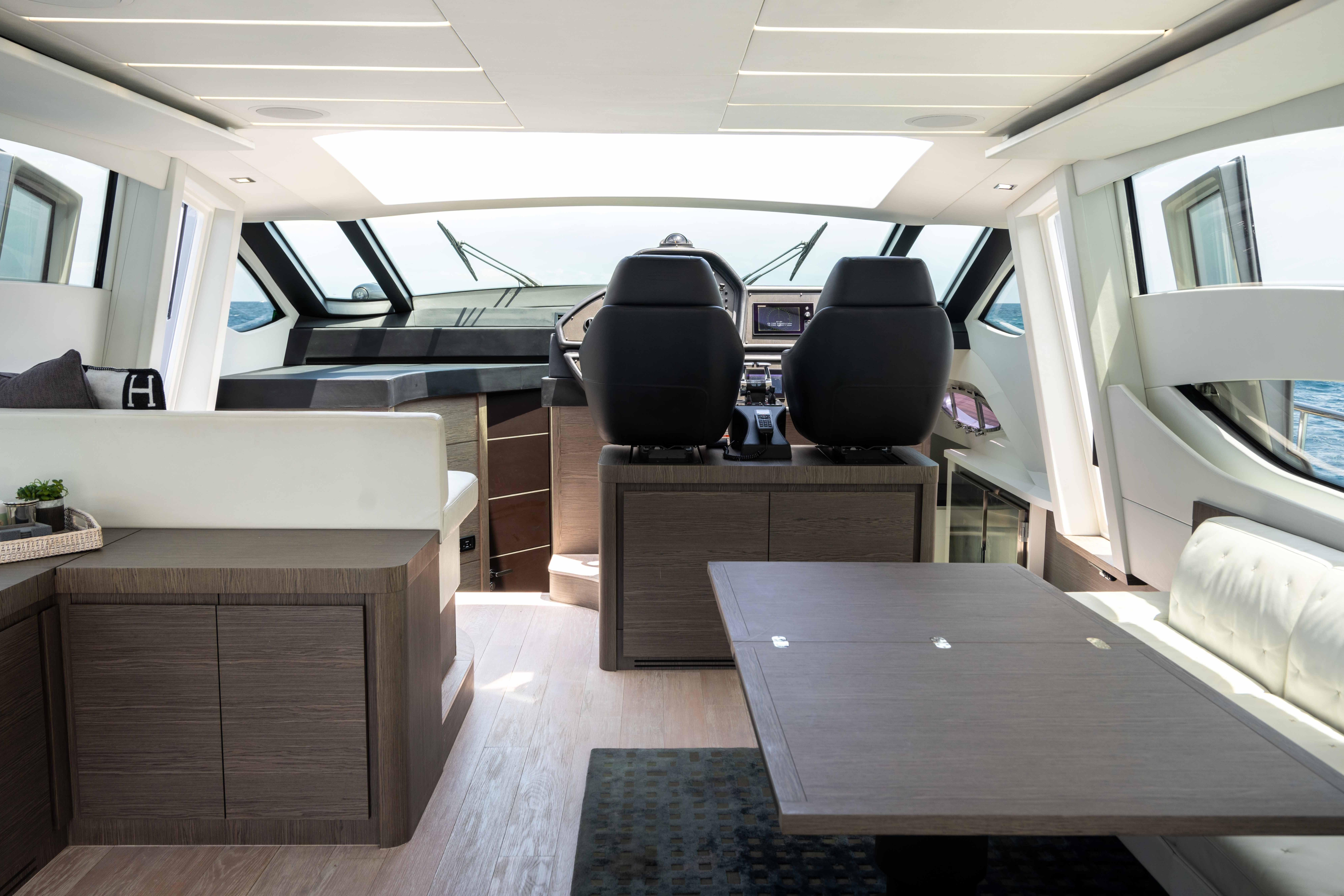 Luxurious interior of a 2017 Pershing 74 yacht with modern helm and seating area.