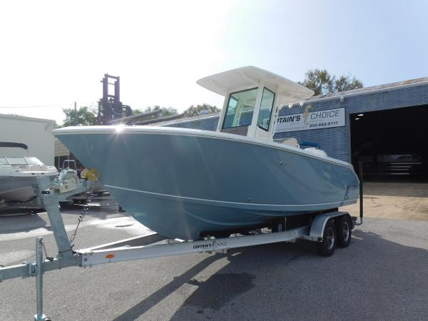 2025 Sailfish 232 CC boat on trailer, parked outside a building.
