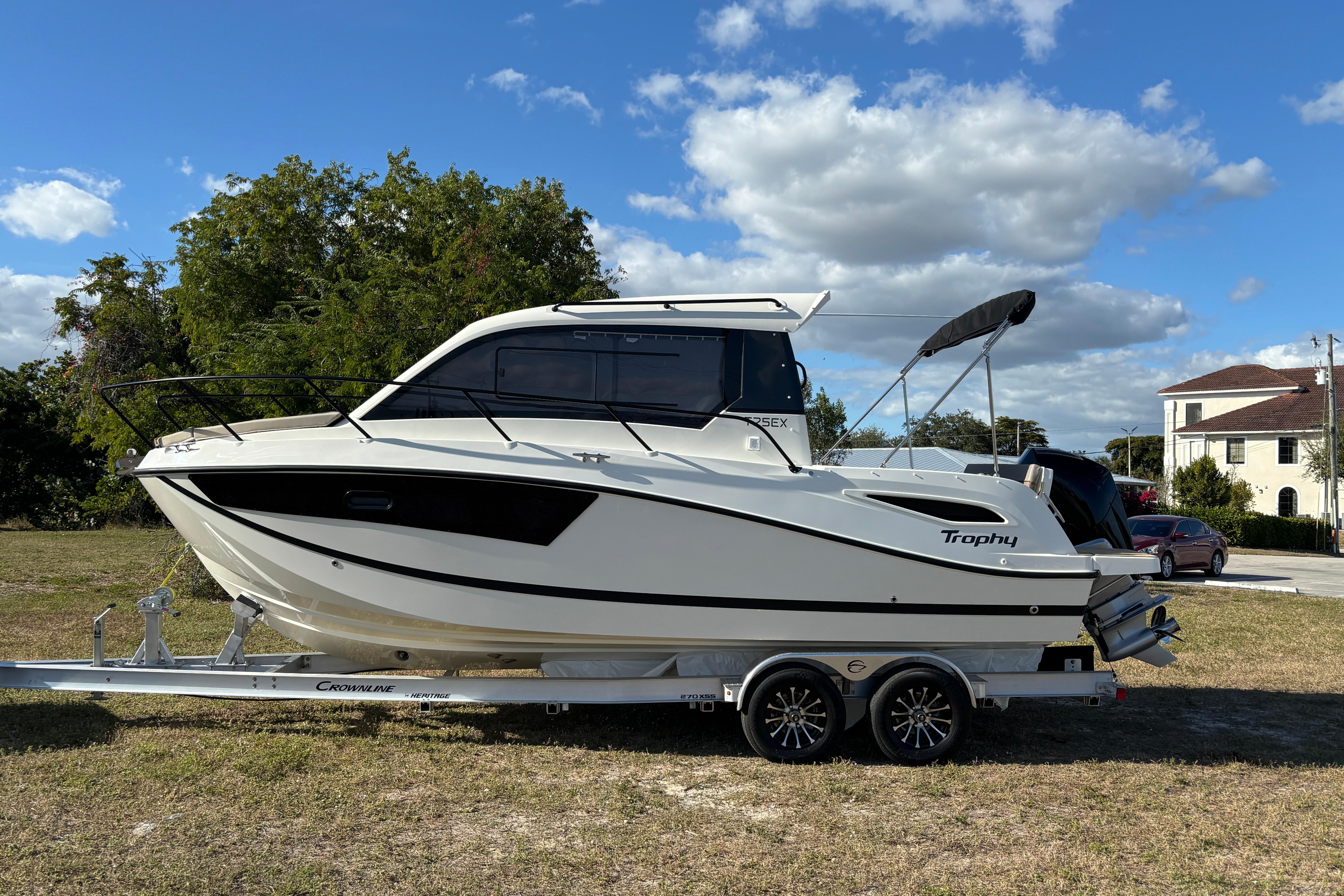 2026 Trophy T 25 Explorer boat on trailer, parked outdoors under a blue sky.