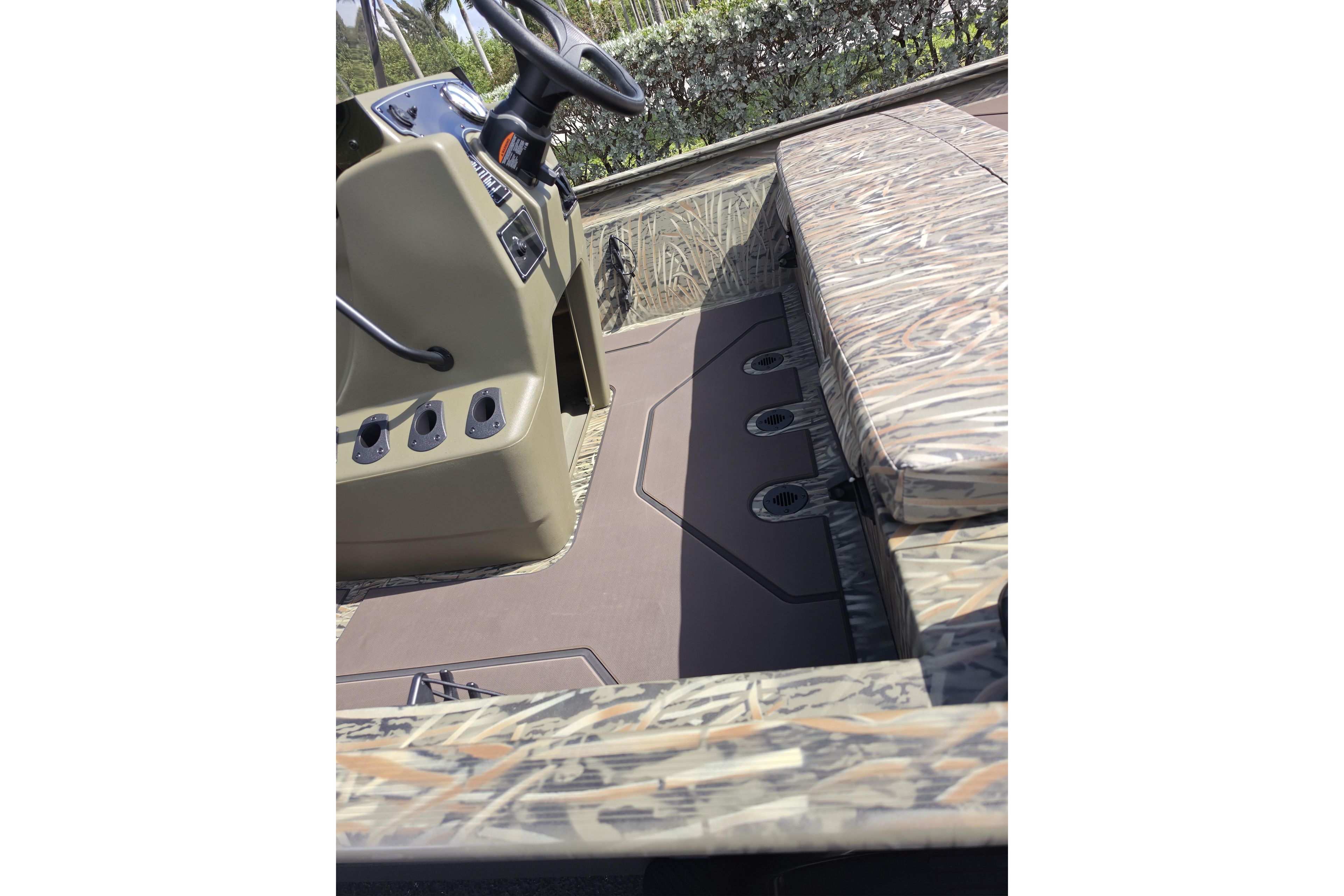 2026 Tracker Grizzly 1860 CC boat interior with camouflage seating and steering console.