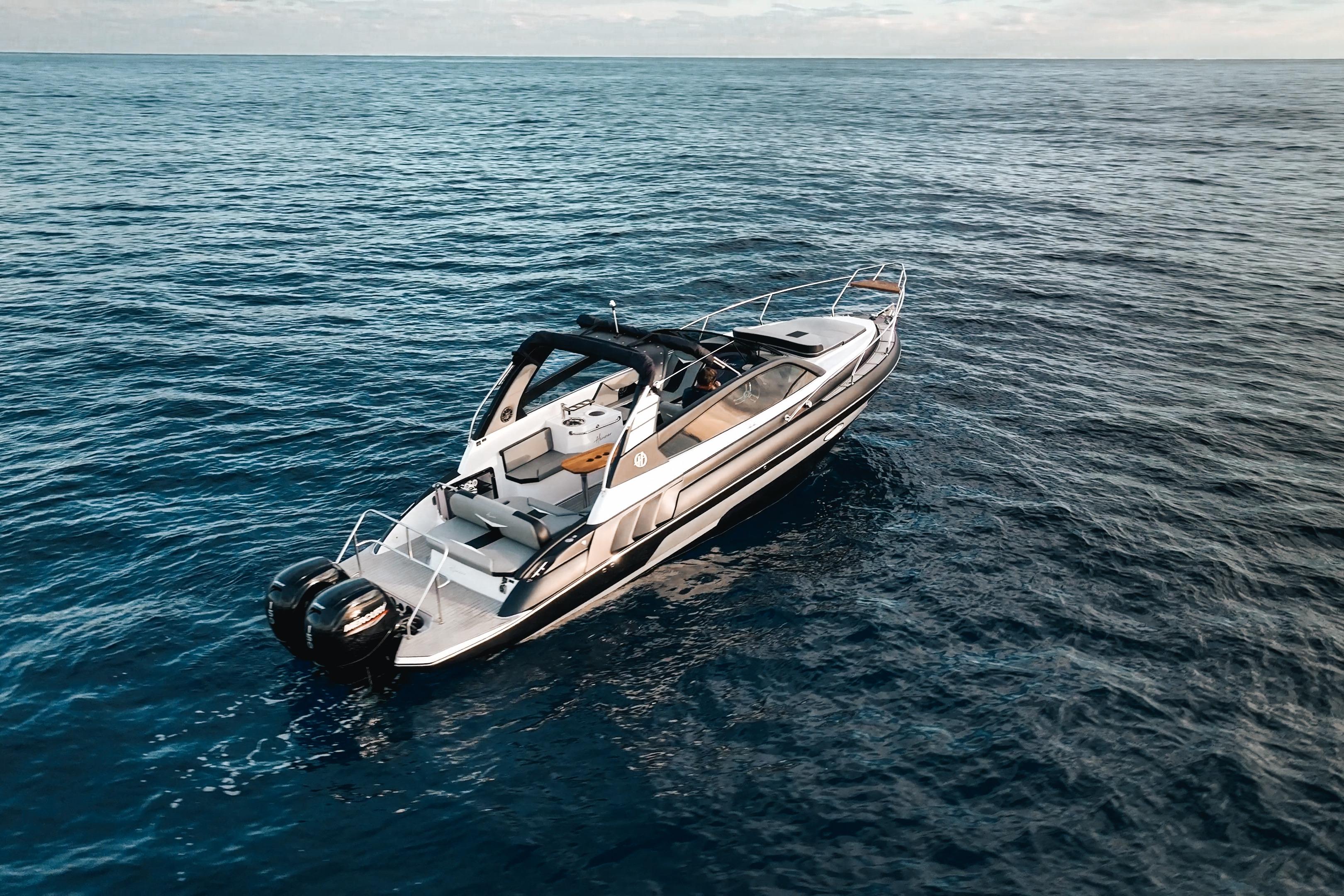 Aerial view of 2027 Hanover 305 boat cruising on open sea.