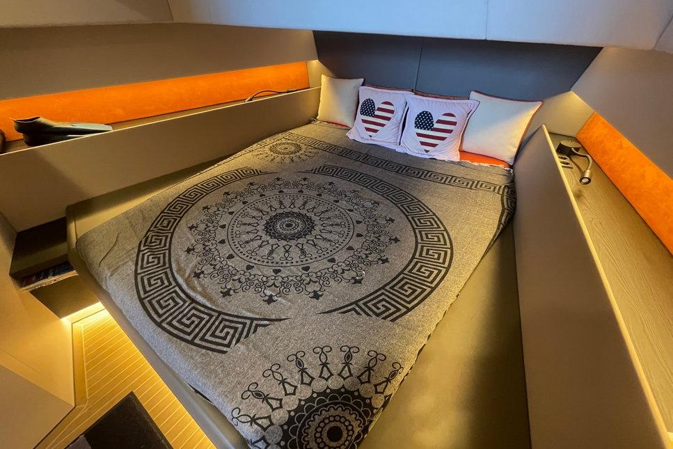 Luxurious 2022 Vanquish Yachts VQ52 cabin with stylish bedding and ambient lighting.