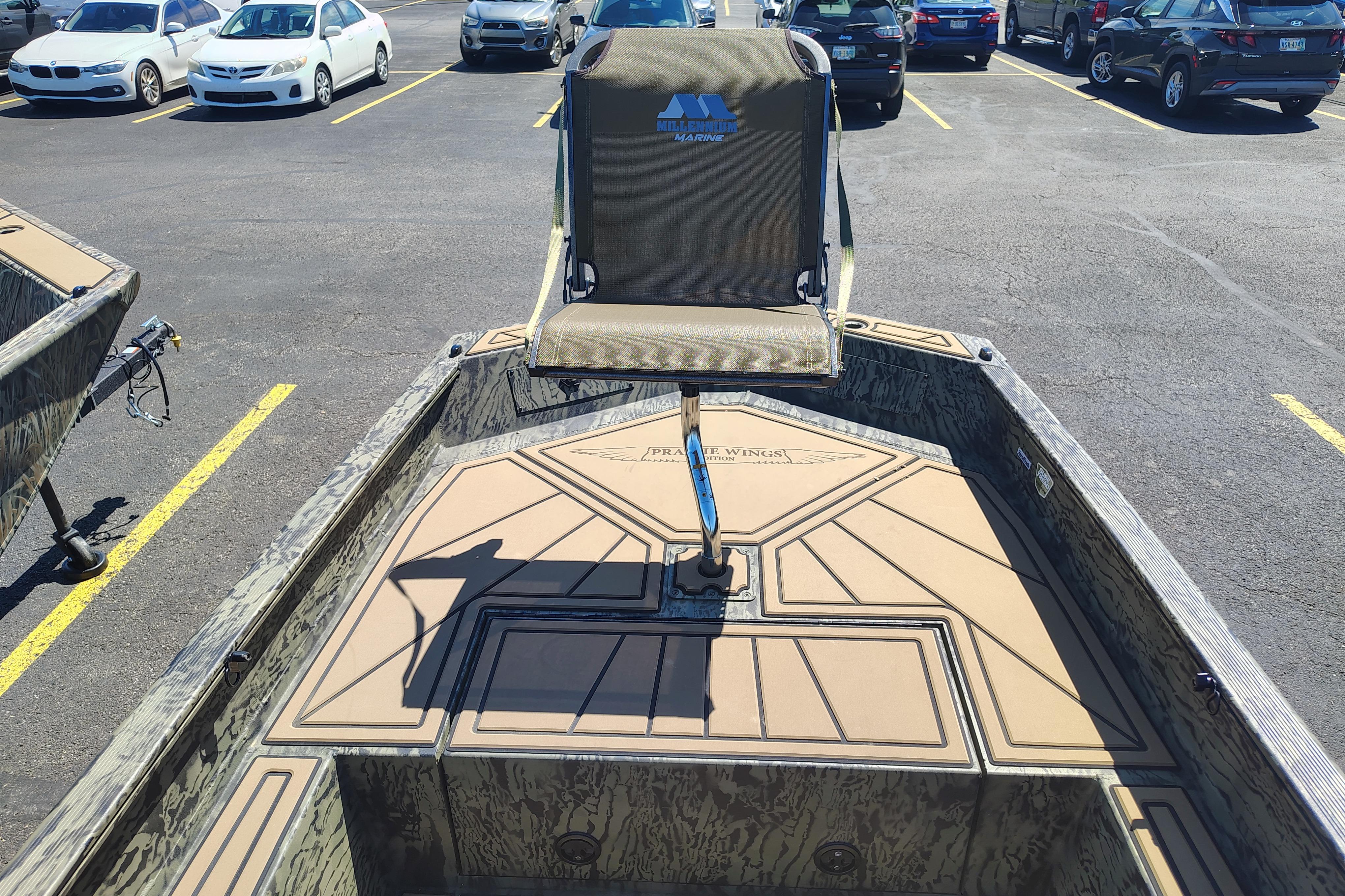 2026 Tracker Grizzly 1650 T Prairie Wings Edition boat in parking lot.