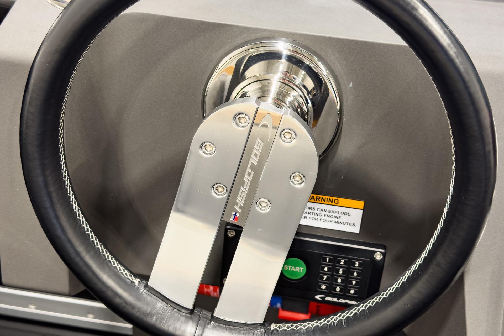Steering wheel of 2016 Goldfish 29 Sport boat with control panel.