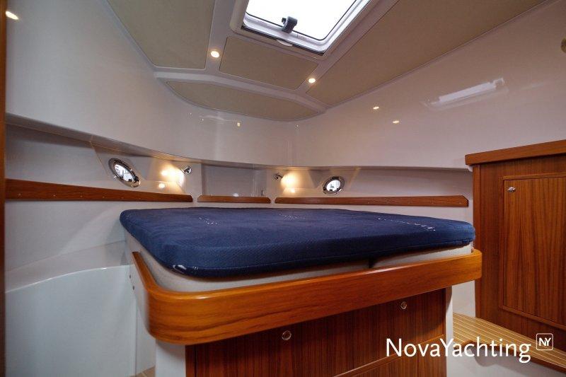 Cabin interior of 2017 Sargo 36 yacht with wooden accents and blue mattress.
